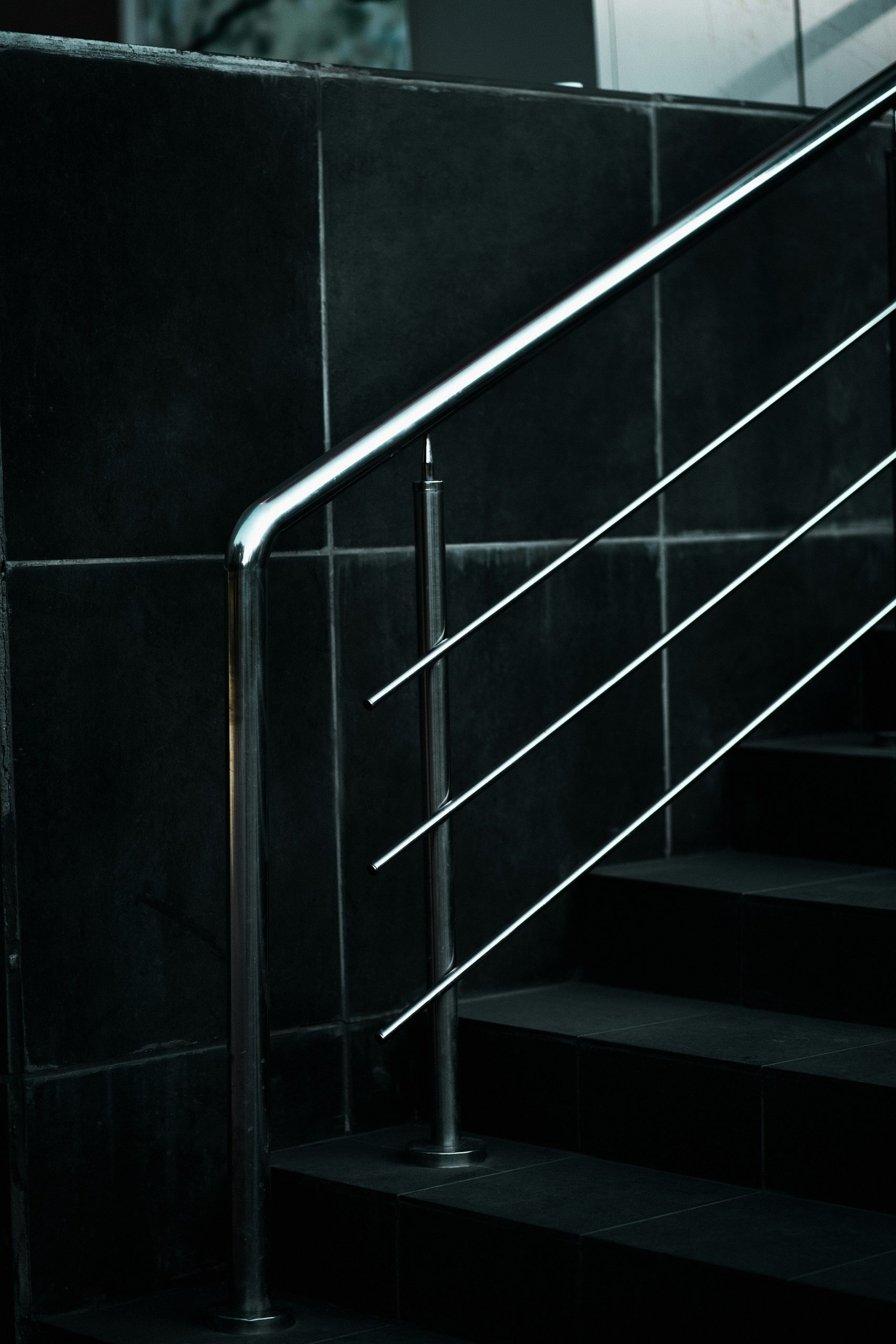 a black and white photo of a stair rail