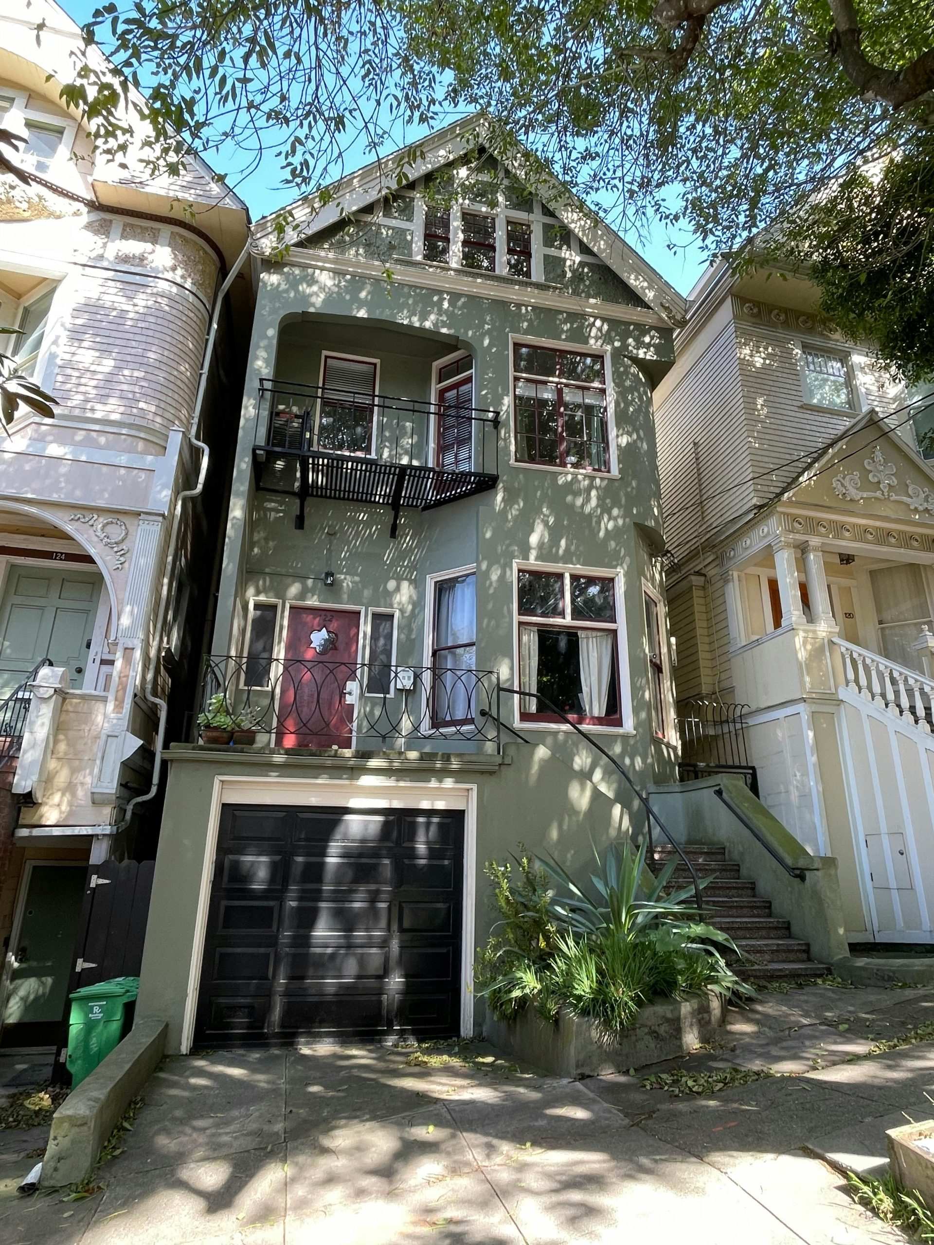 A classic Victorian-style house in San Francisco, showcasing bay windows and intricate details.