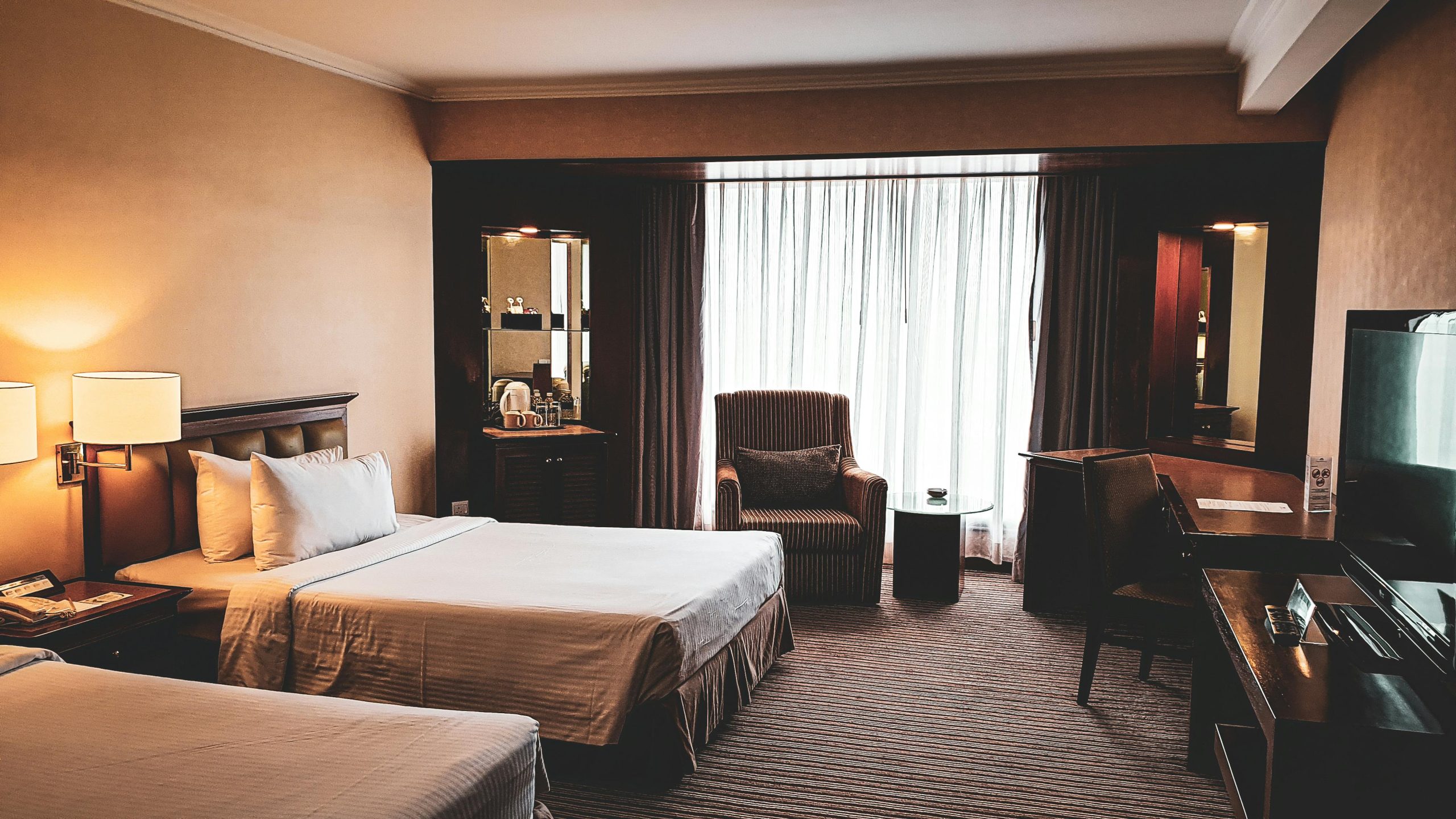 A cozy and elegantly furnished hotel room in Johor Bahru, showcasing modern design and comfort.