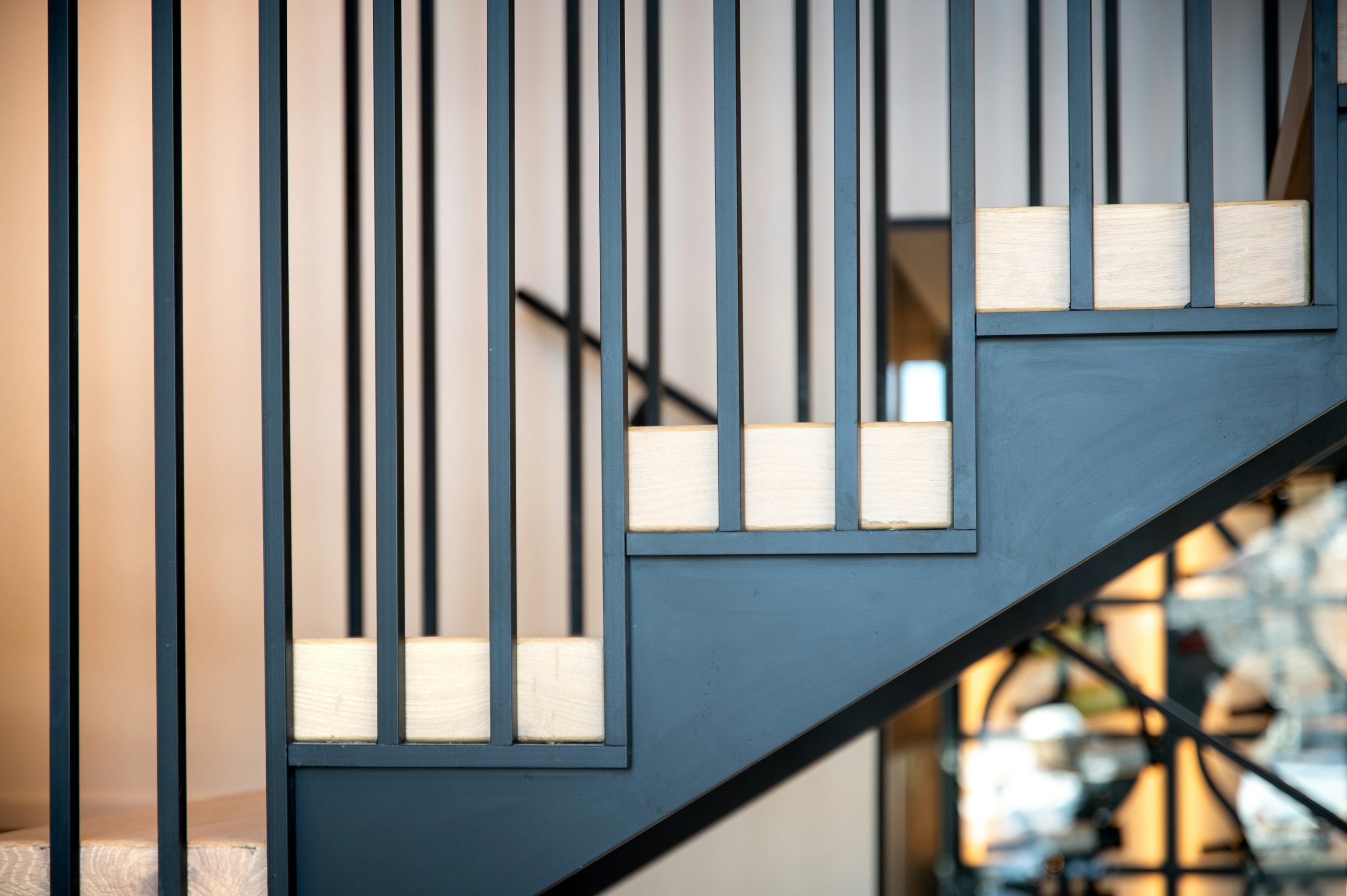 A stair case with a glass railing and a clock