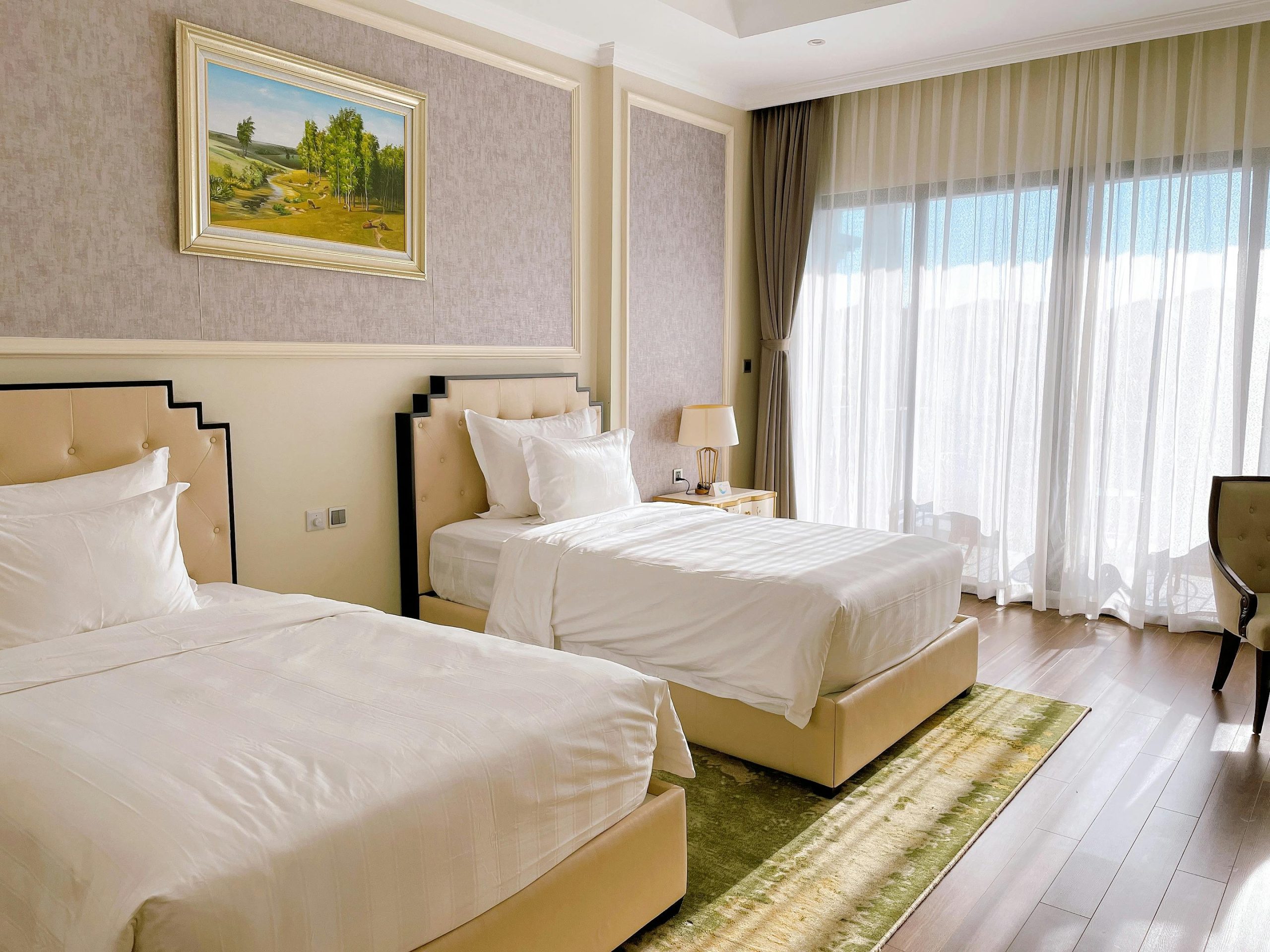 A sunlit bedroom with twin beds and elegant decor perfect for relaxation.