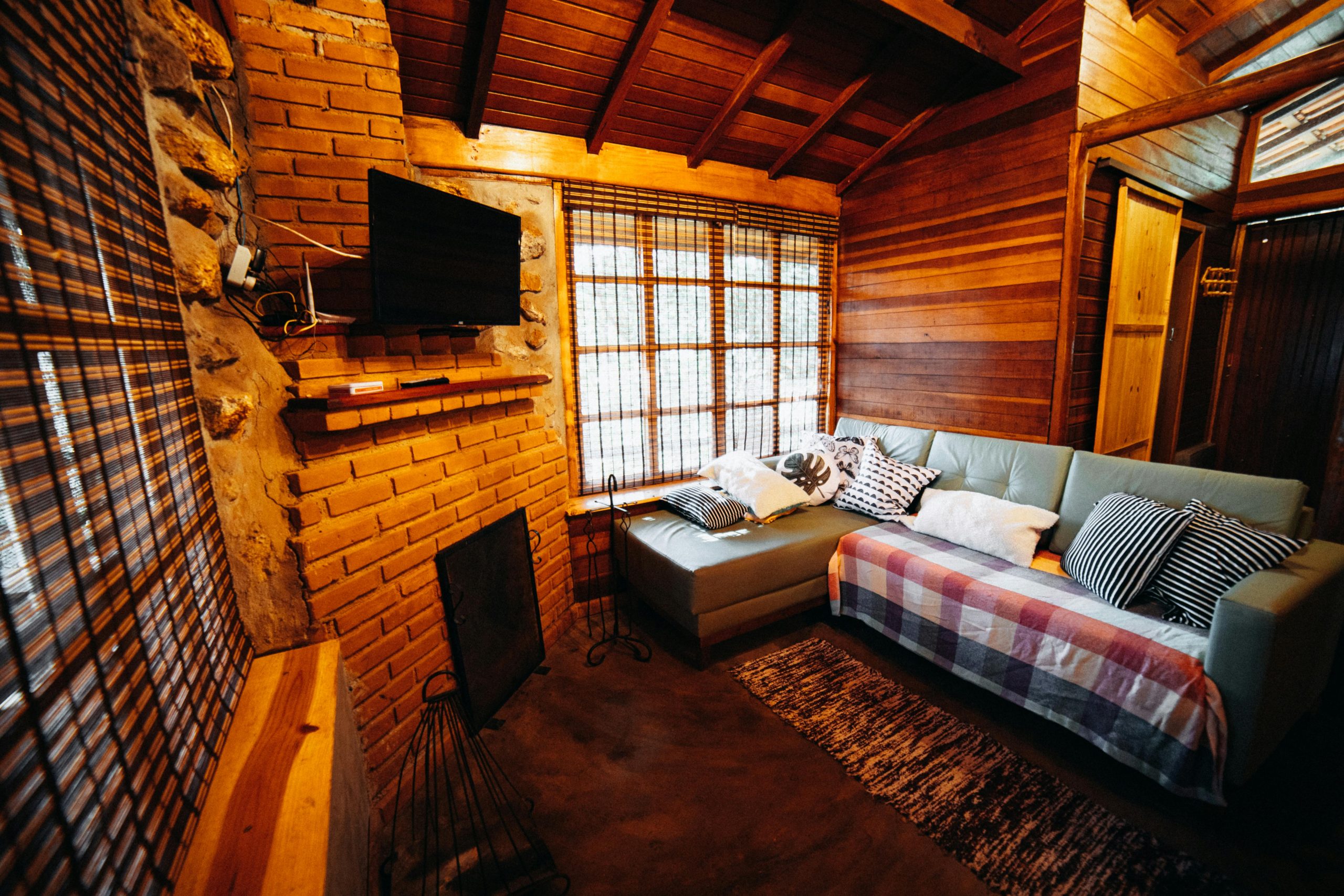 A warm and inviting rustic living room interior within a wooden cabin setting.