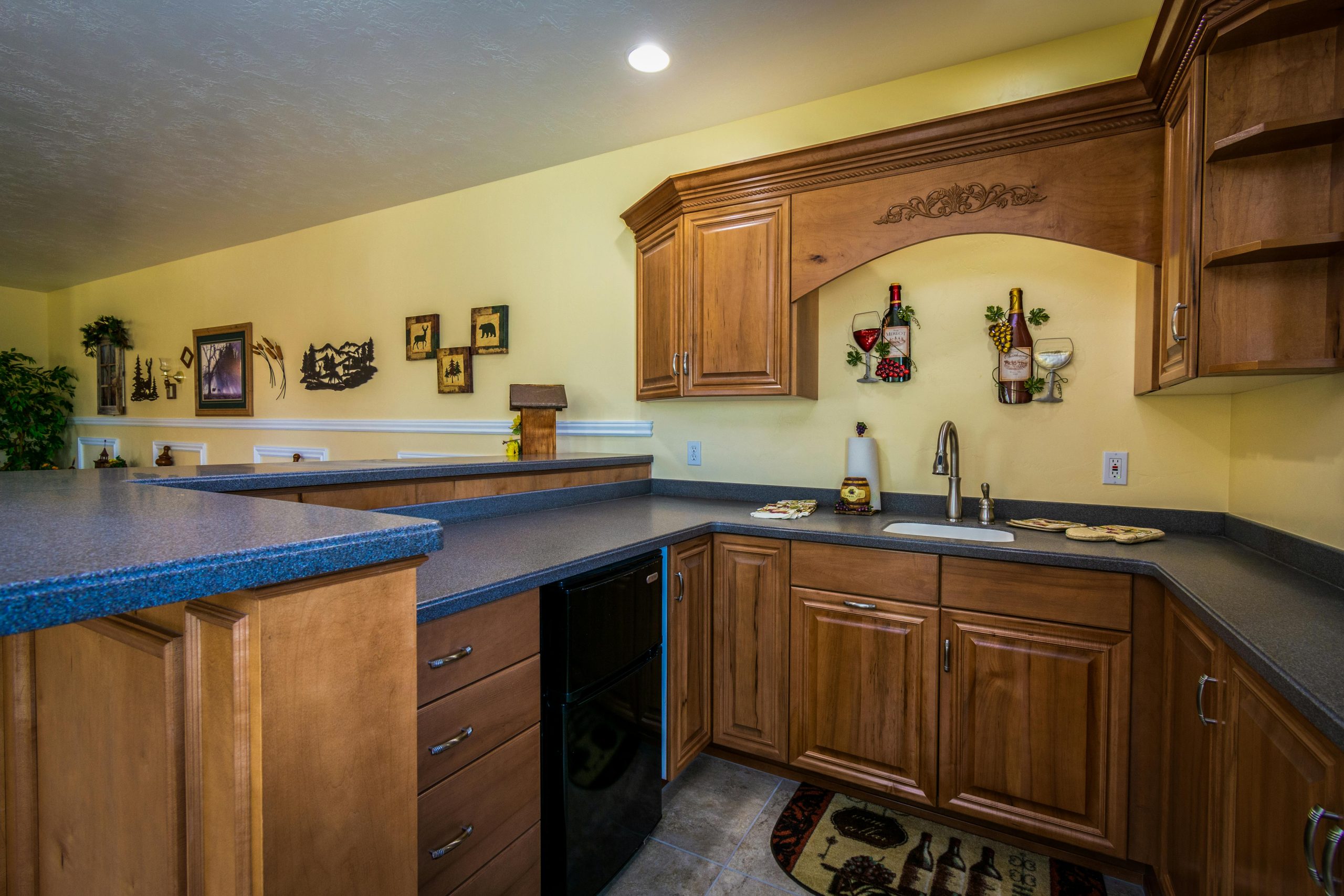 A warm-toned kitchen featuring wooden cabinetry and contemporary decor.