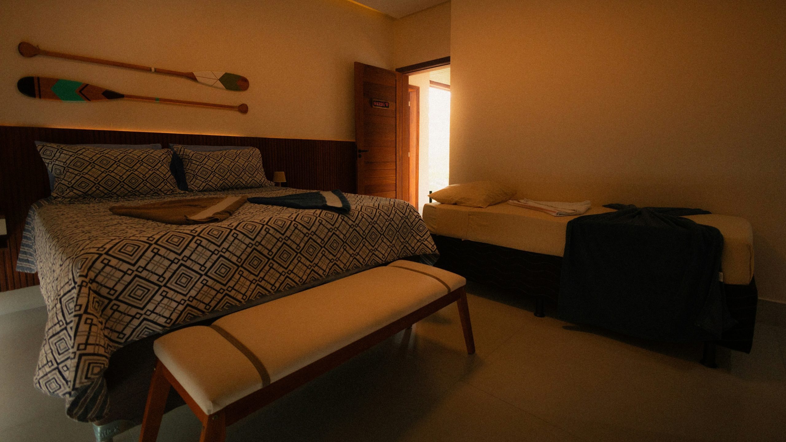 Bedroom with two beds and decorative paddles.