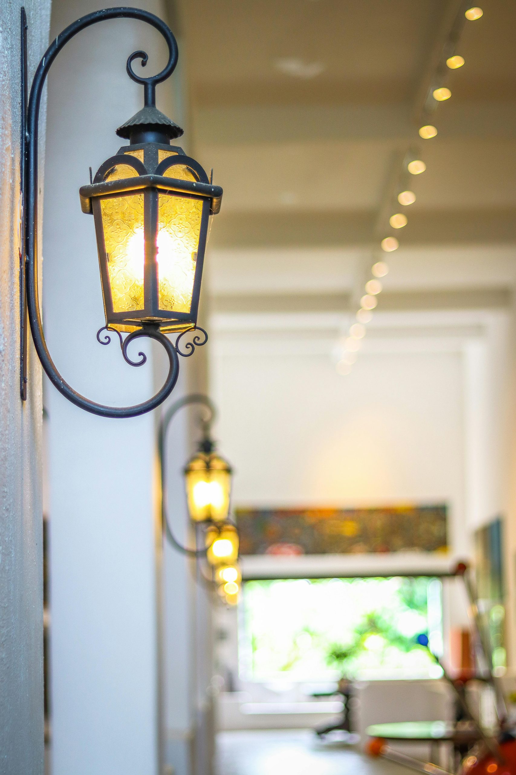Charming vintage lanterns beautifully illuminate an indoor hallway with a cozy ambiance.