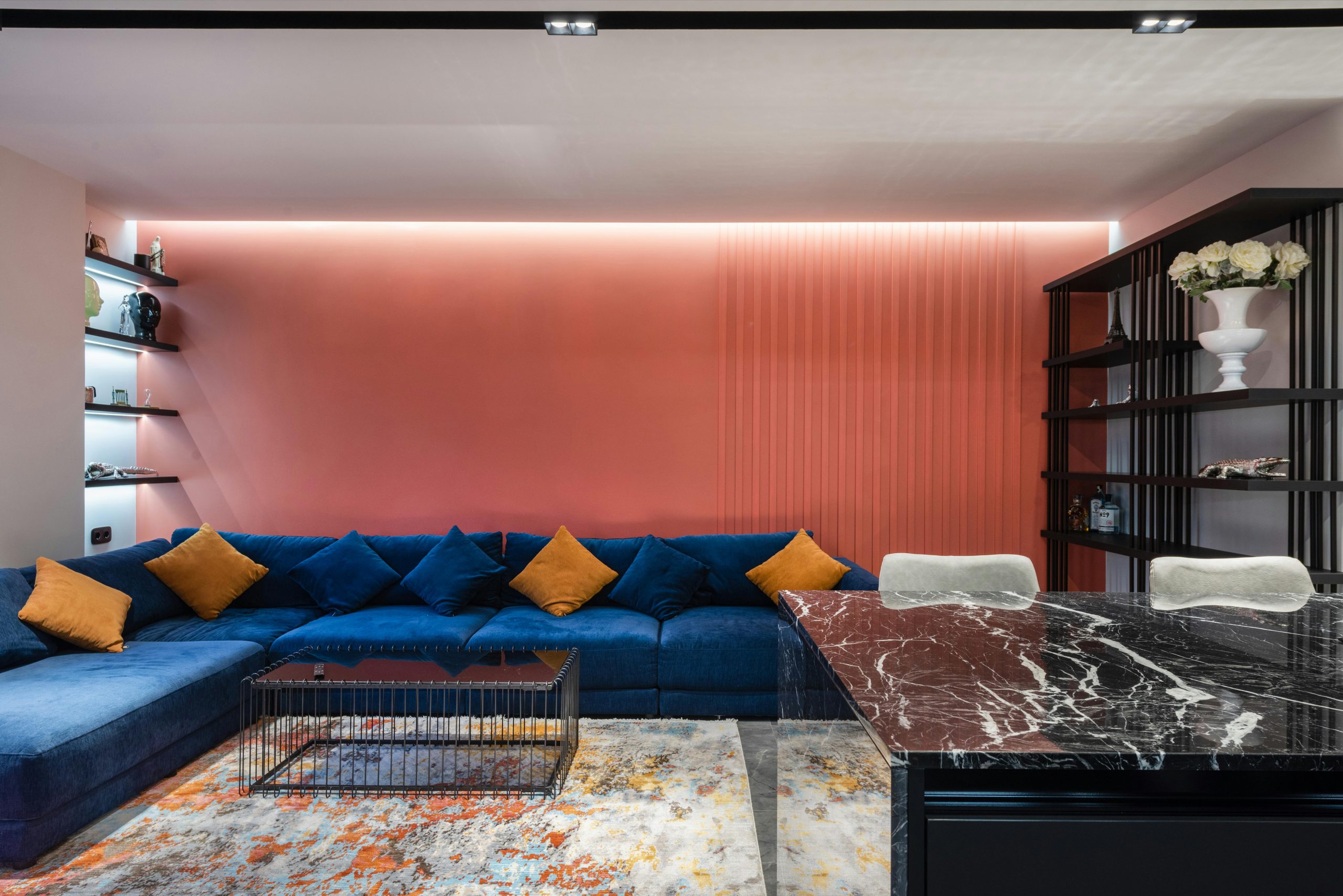 Contemporary living room interior with couch and table on rug with abstract ornament at home