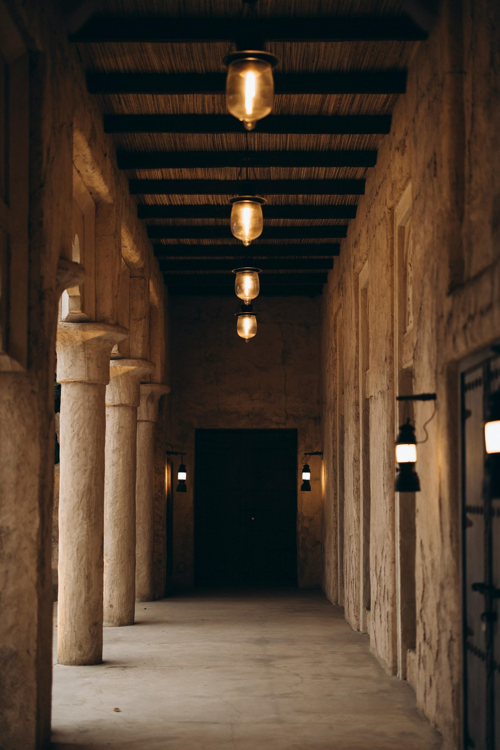 Explore the rustic charm of a traditional corridor in Shindagha, Dubai, featuring warm atmospheric lighting.