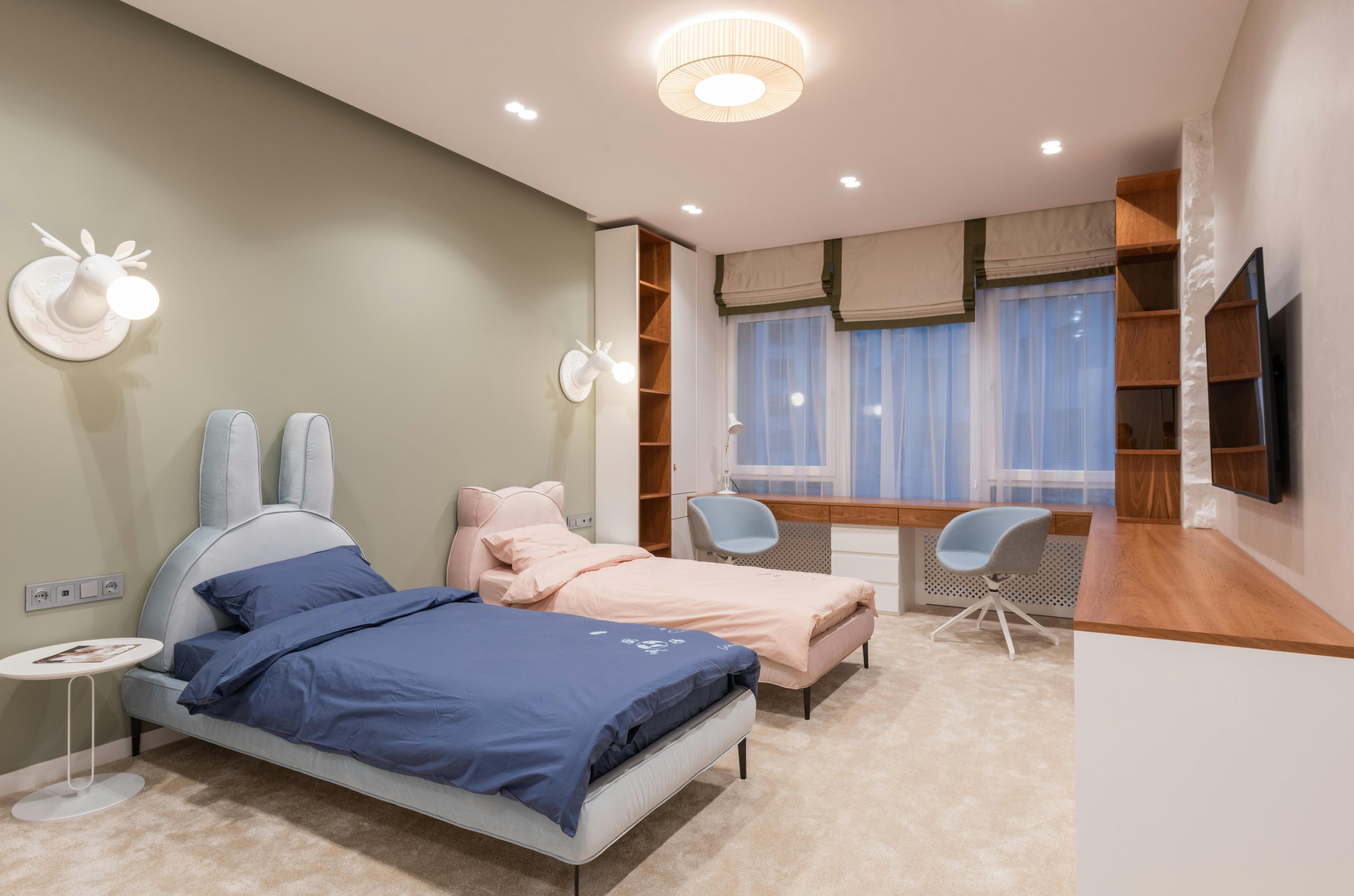 Interior of empty contemporary bedroom for children with stylish beds placed in modern apartment