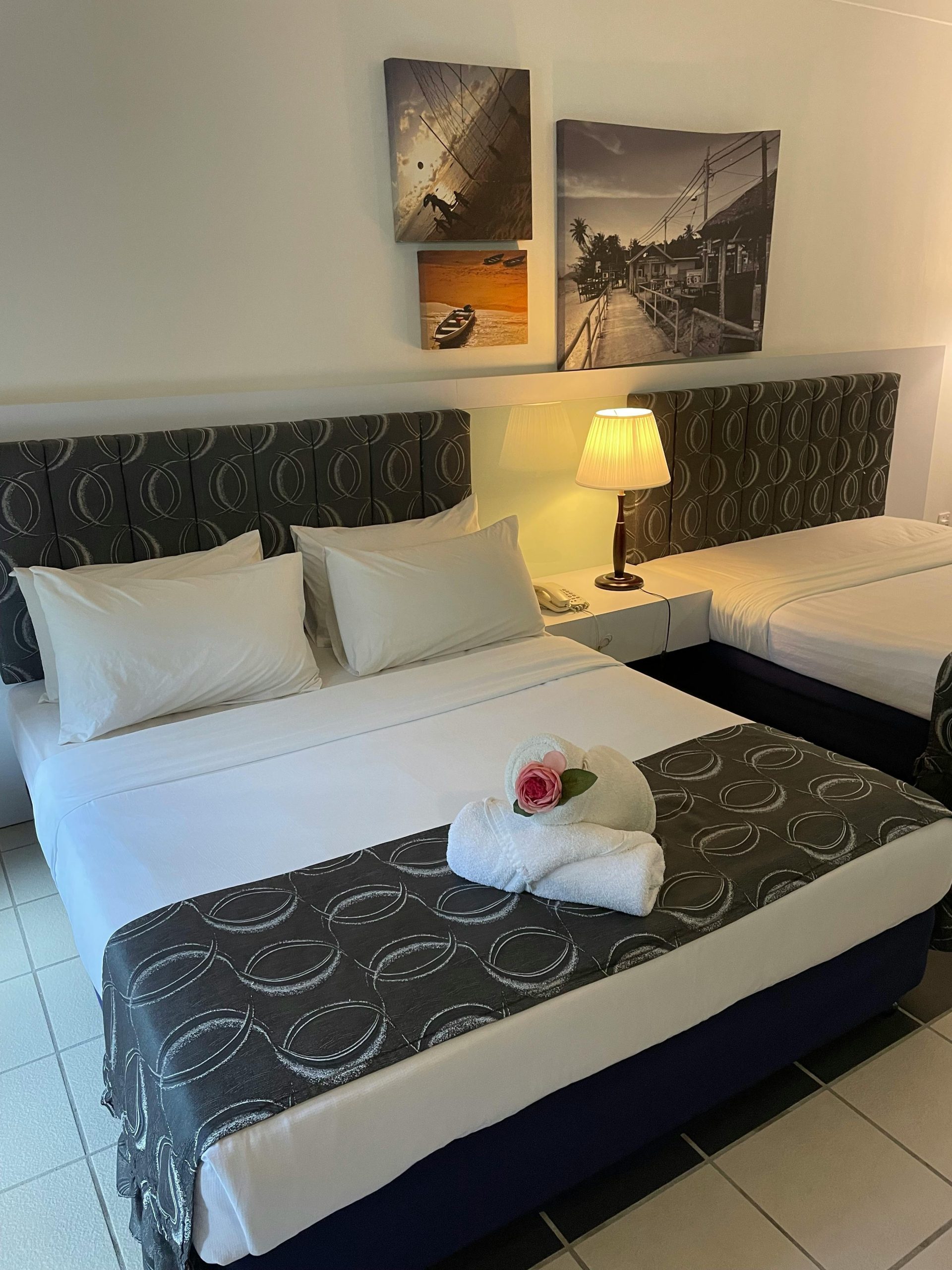 Inviting hotel room featuring stylish decor, twin beds, and ambient lighting.
