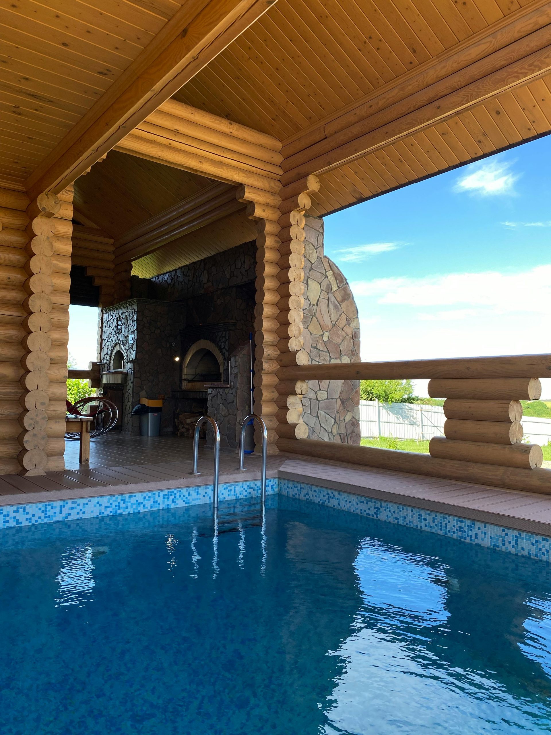 Inviting indoor pool surrounded by rustic wooden log cabin design, ideal for relaxation.