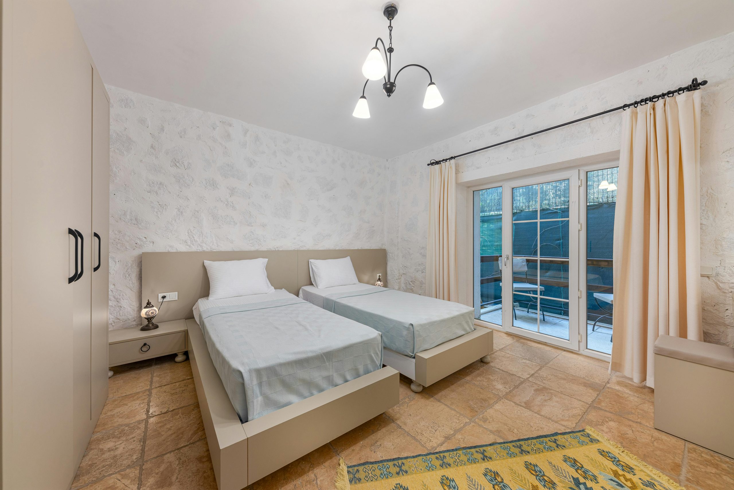 Modern hotel room with twin beds and elegant decor, perfect for travel stays.
