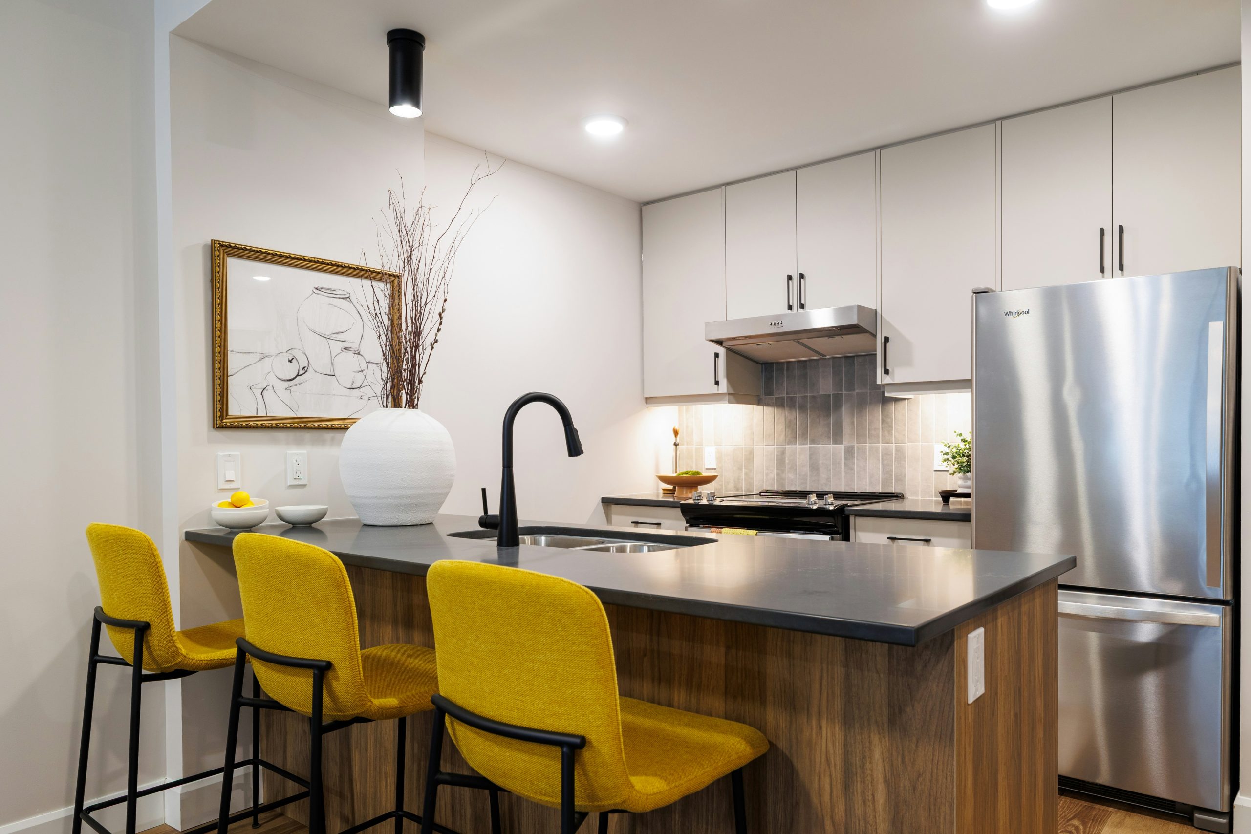 Modern kitchen with island and yellow bar stools
