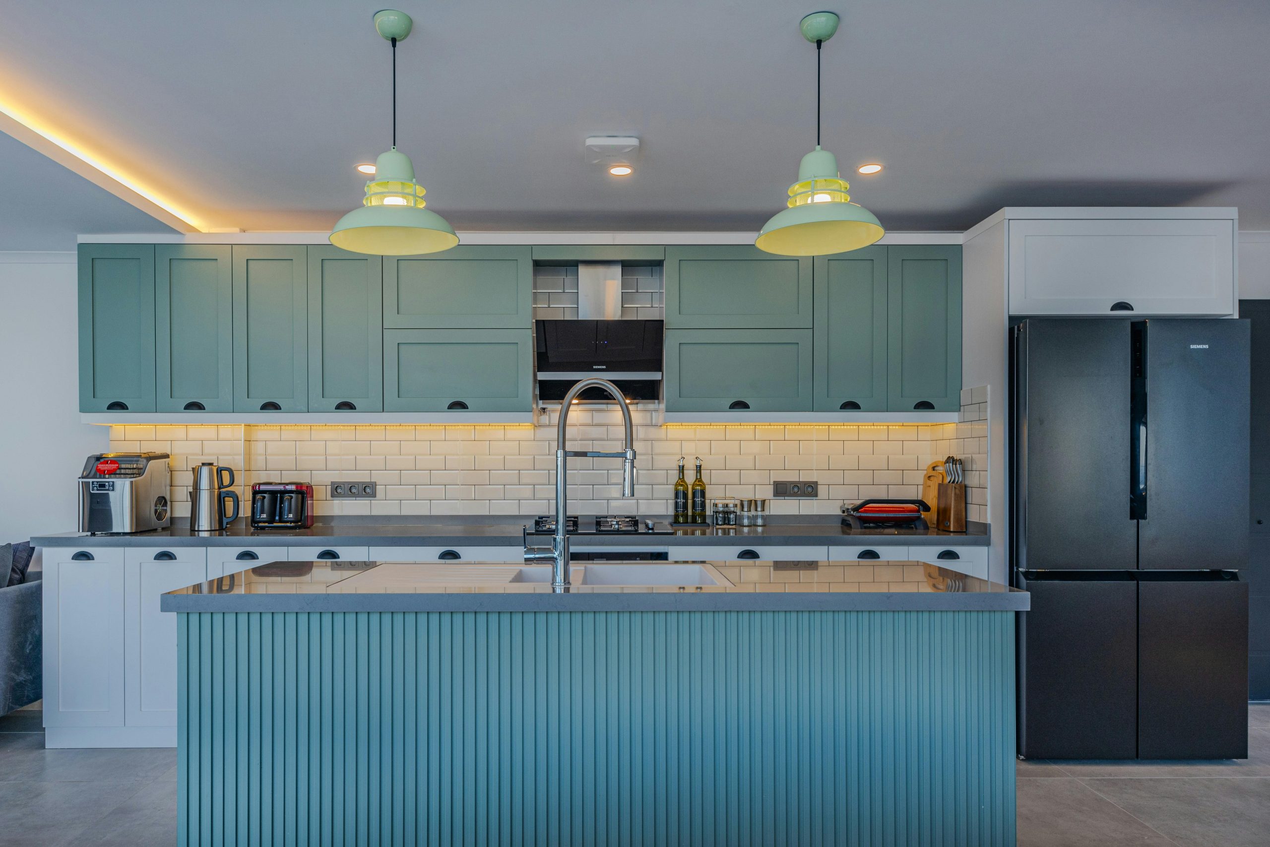 Sleek contemporary kitchen with blue cabinets and stainless steel appliances.