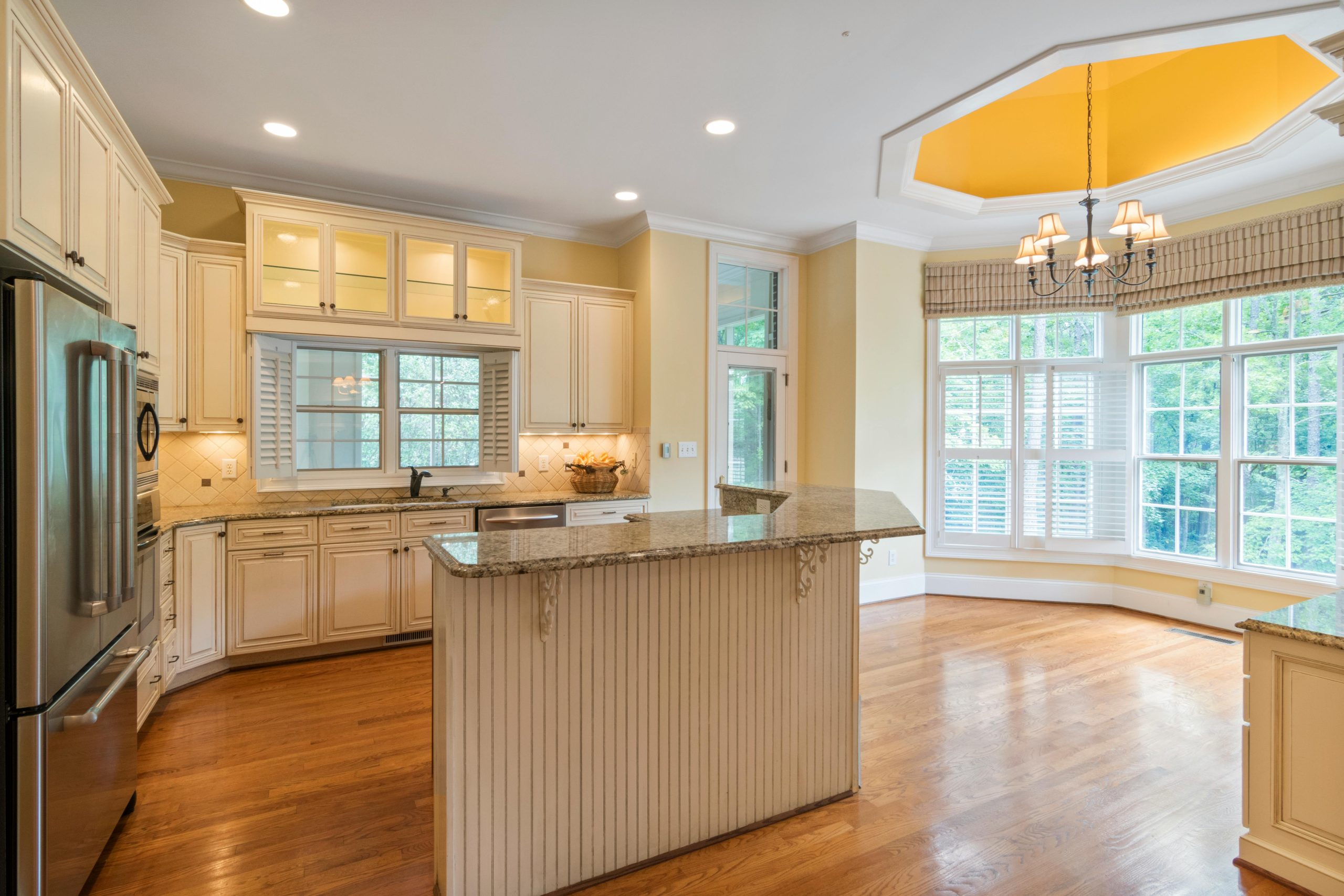 Spacious modern kitchen featuring granite countertops and ample natural light.