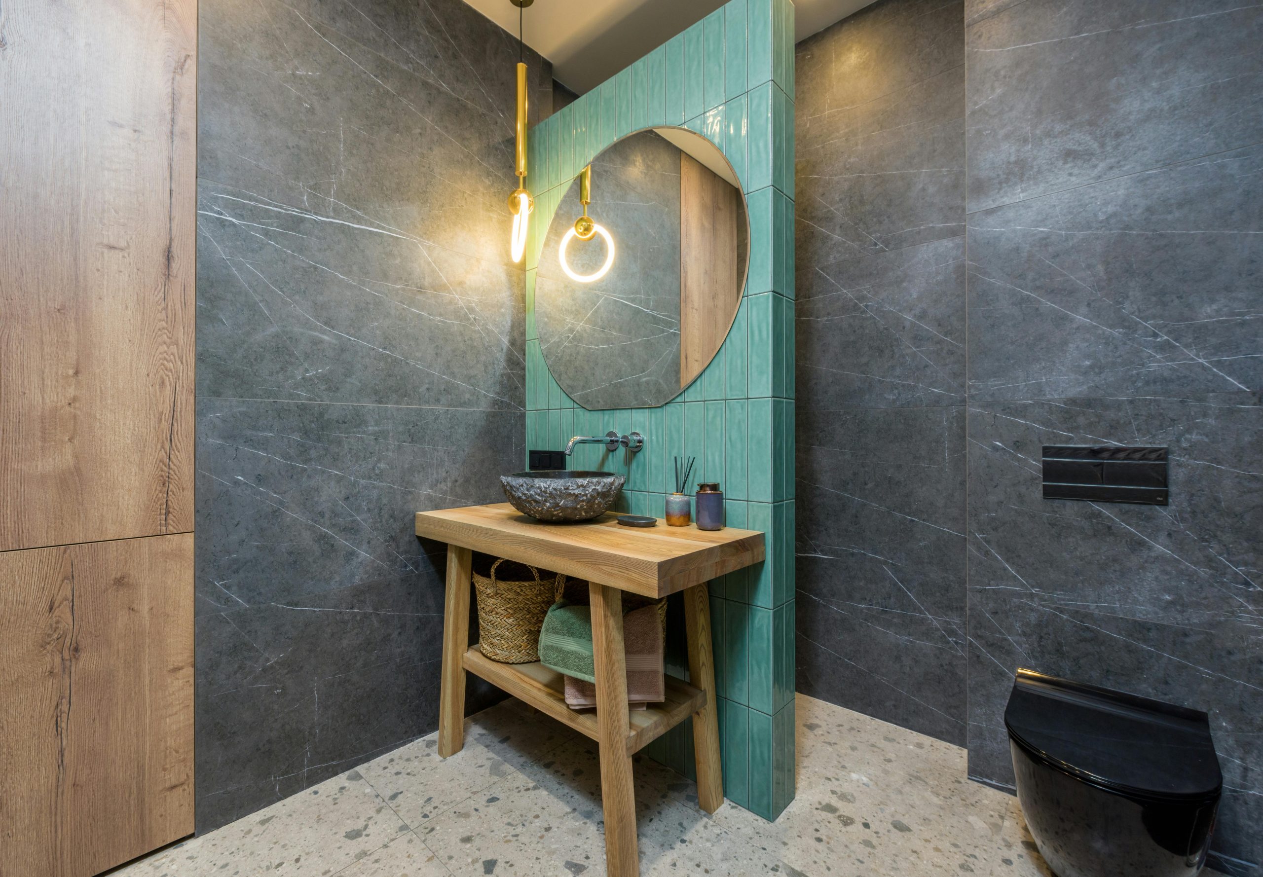 Stylish bathroom featuring a unique mirror and elegant decor elements.