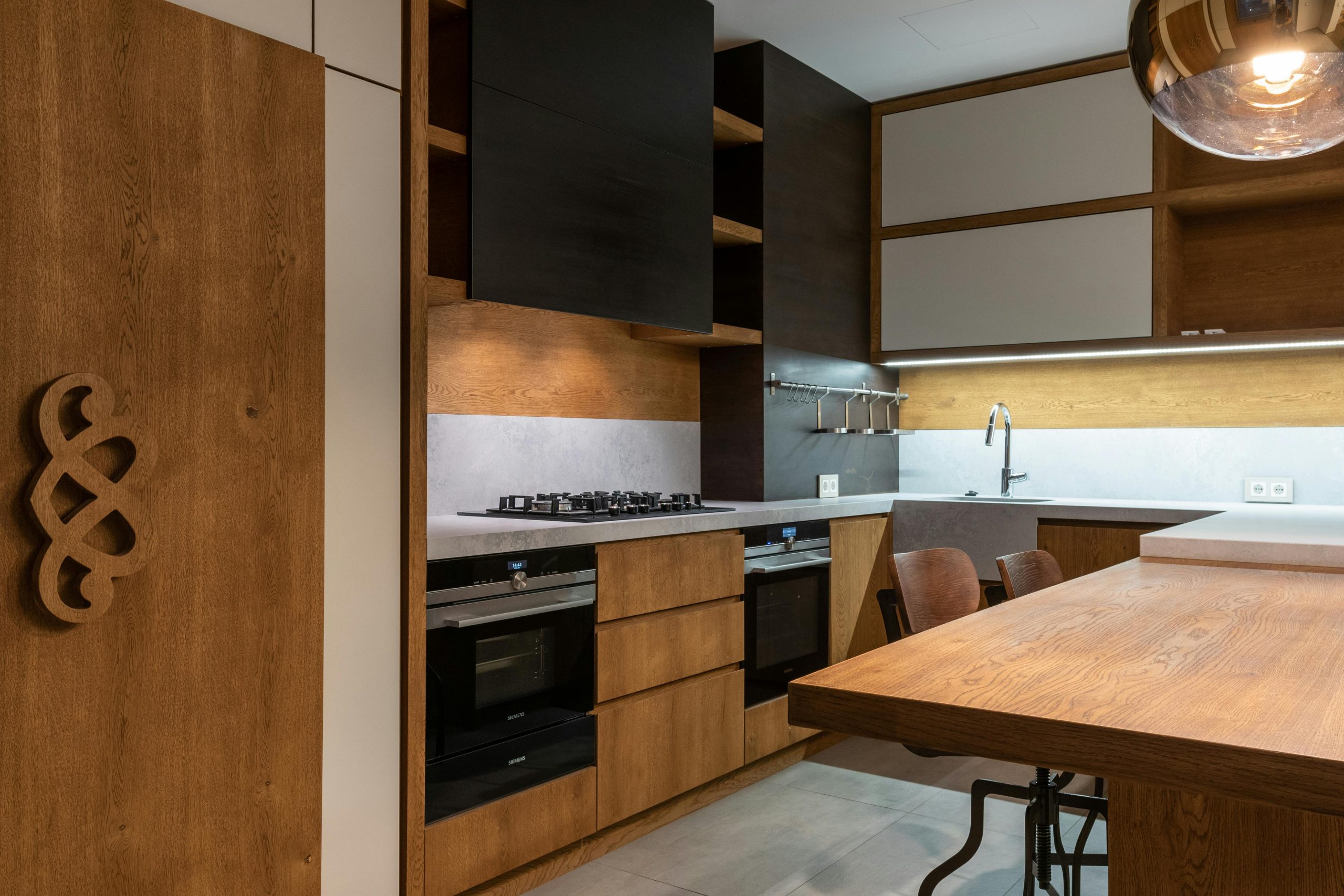 Stylish contemporary kitchen featuring wooden accents and modern appliances.