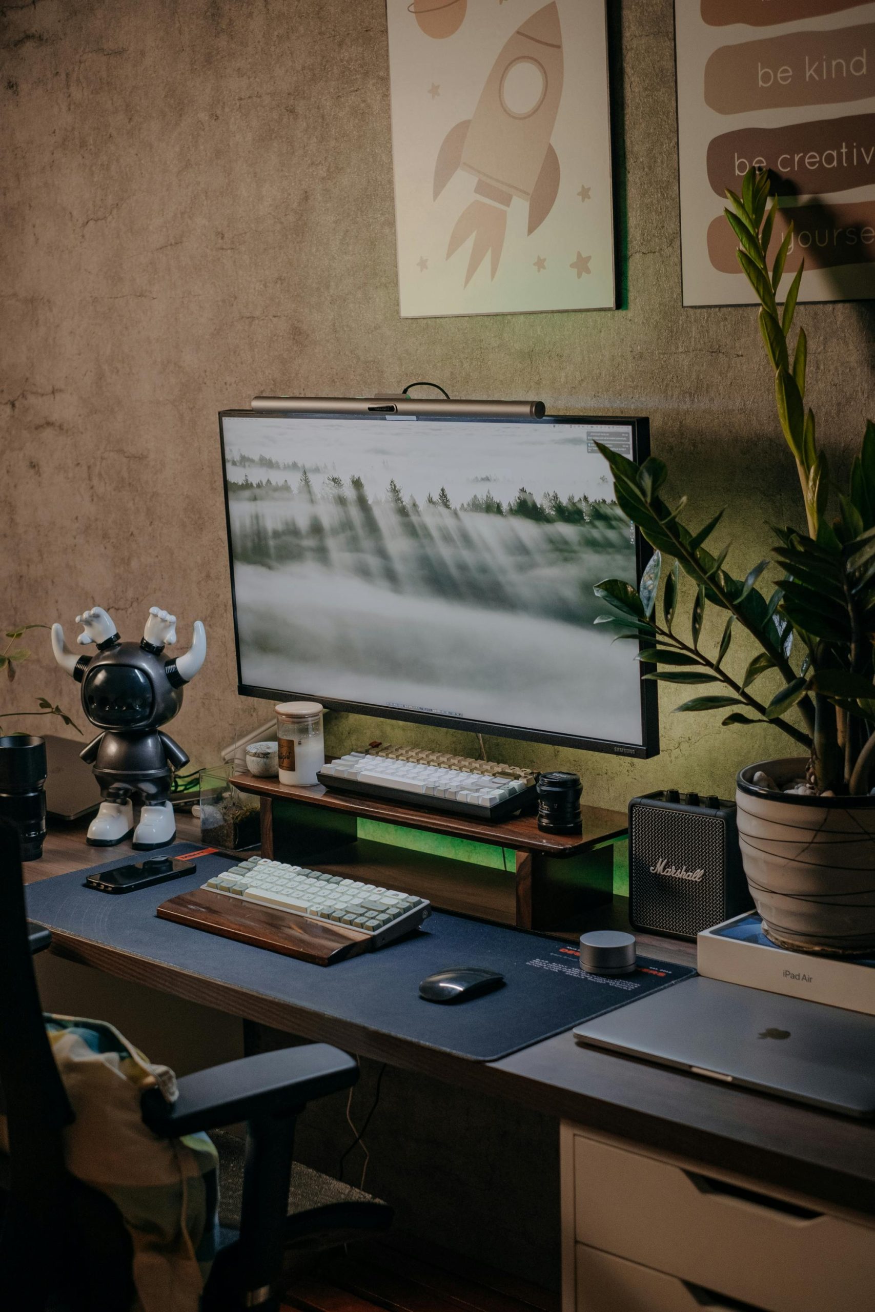 Stylish home office desk with monitor, plants, and creative decor