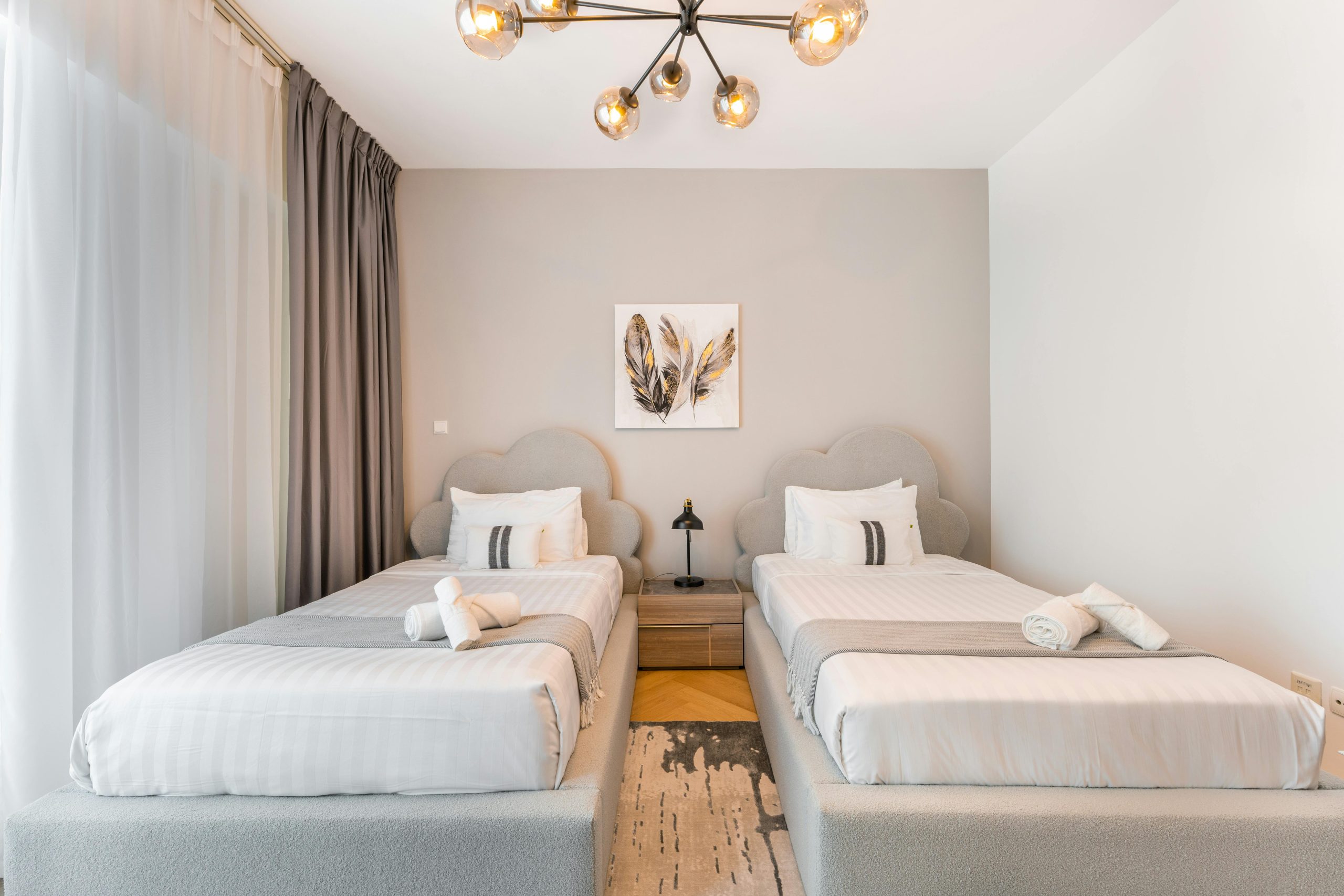 Stylish twin bedroom featuring modern decor and elegant design elements for a relaxing stay.