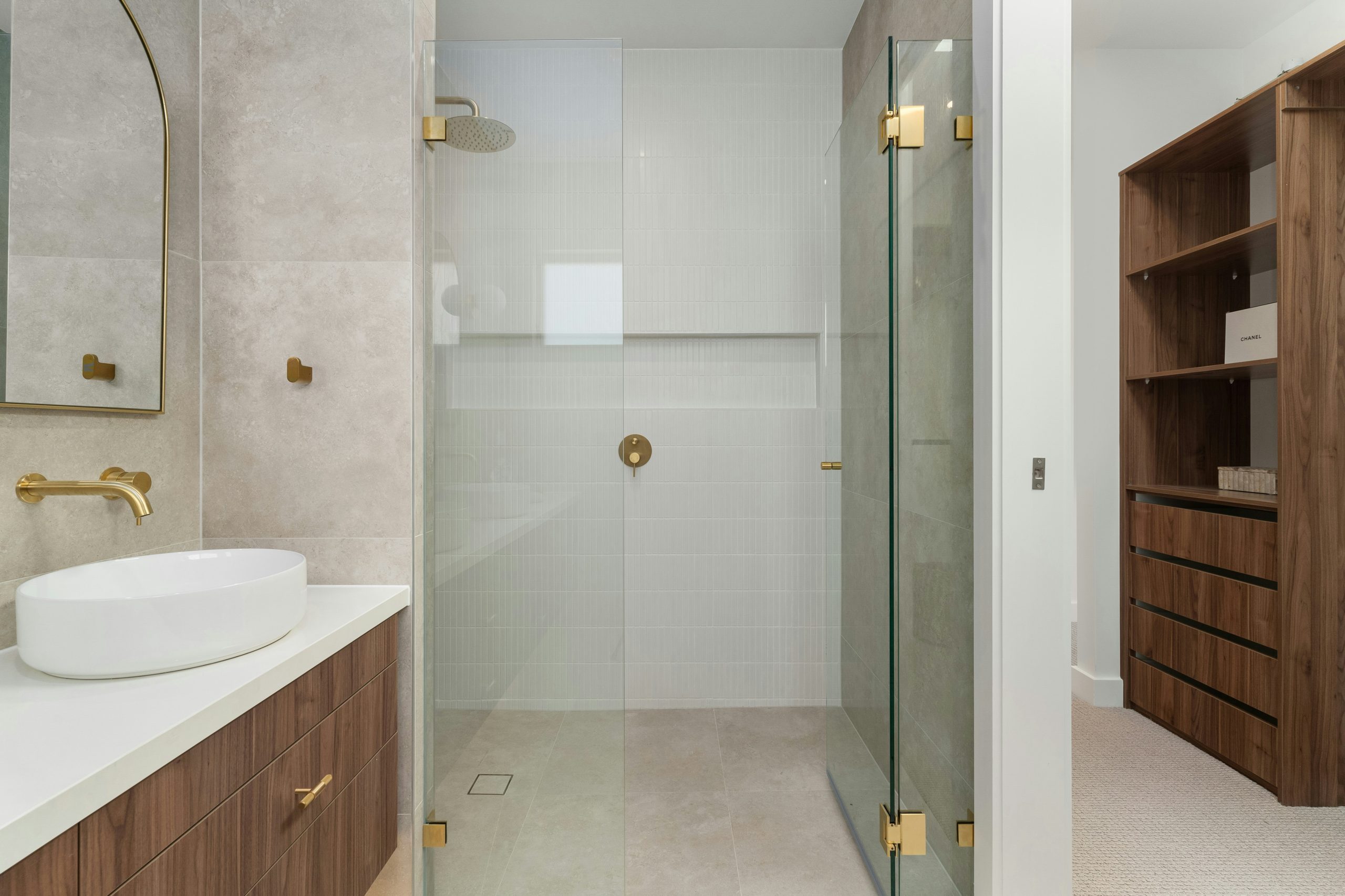 A bathroom with a walk in shower next to a sink