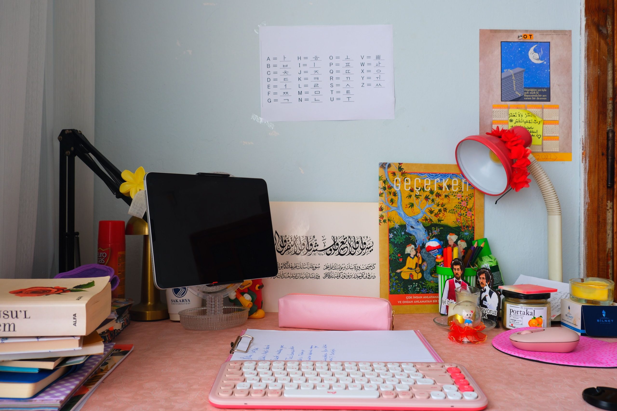 A colorful and organized study desk with books, a keyboard, and a tablet, perfect for creativity and learning.