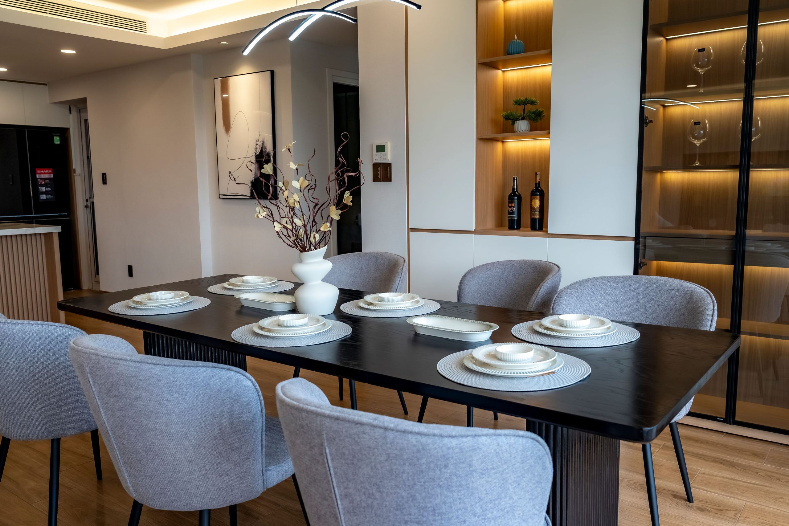 A contemporary dining room with modern decor and elegant table setup.