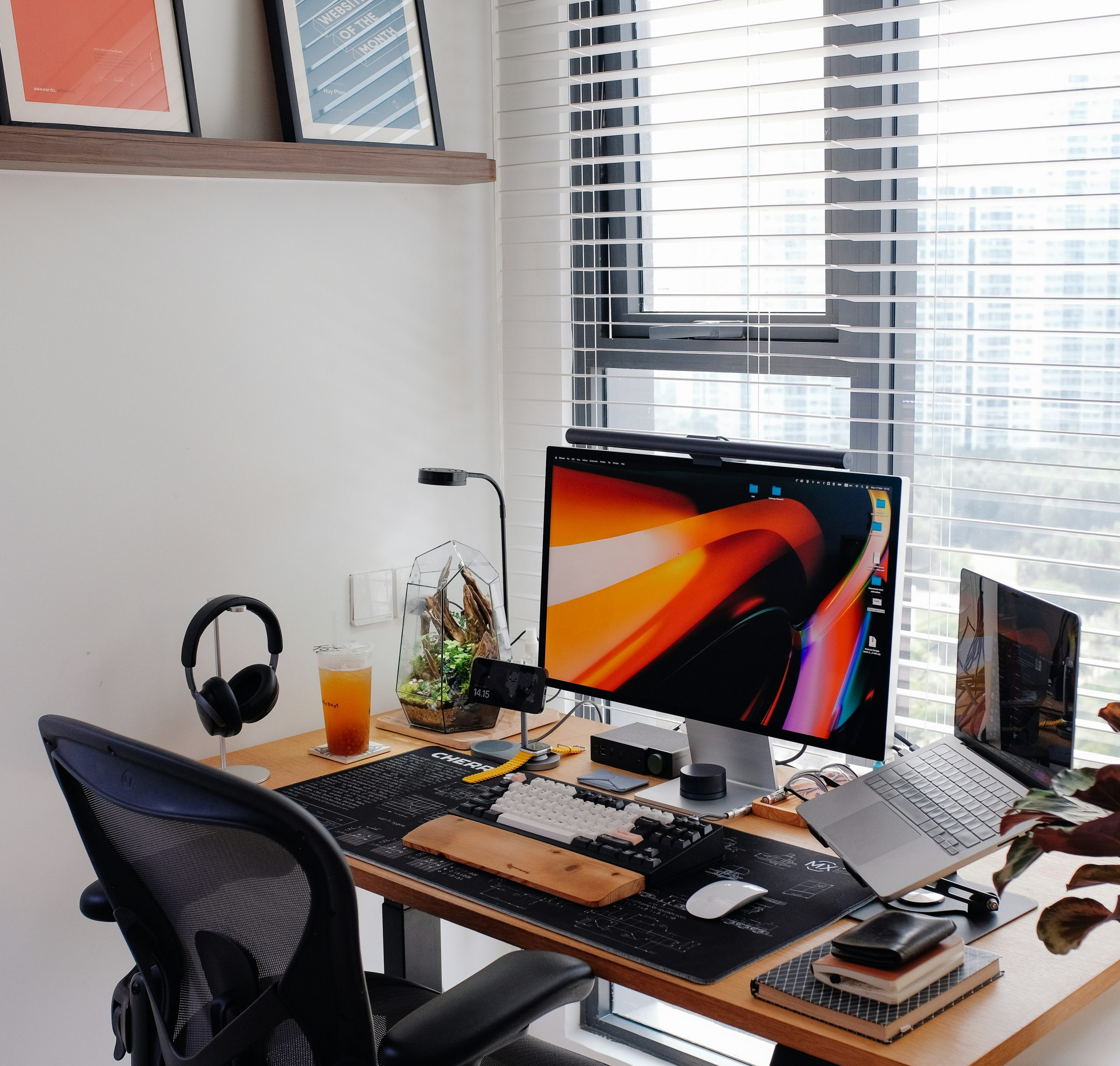 A home office workspace with many tech gadgets.