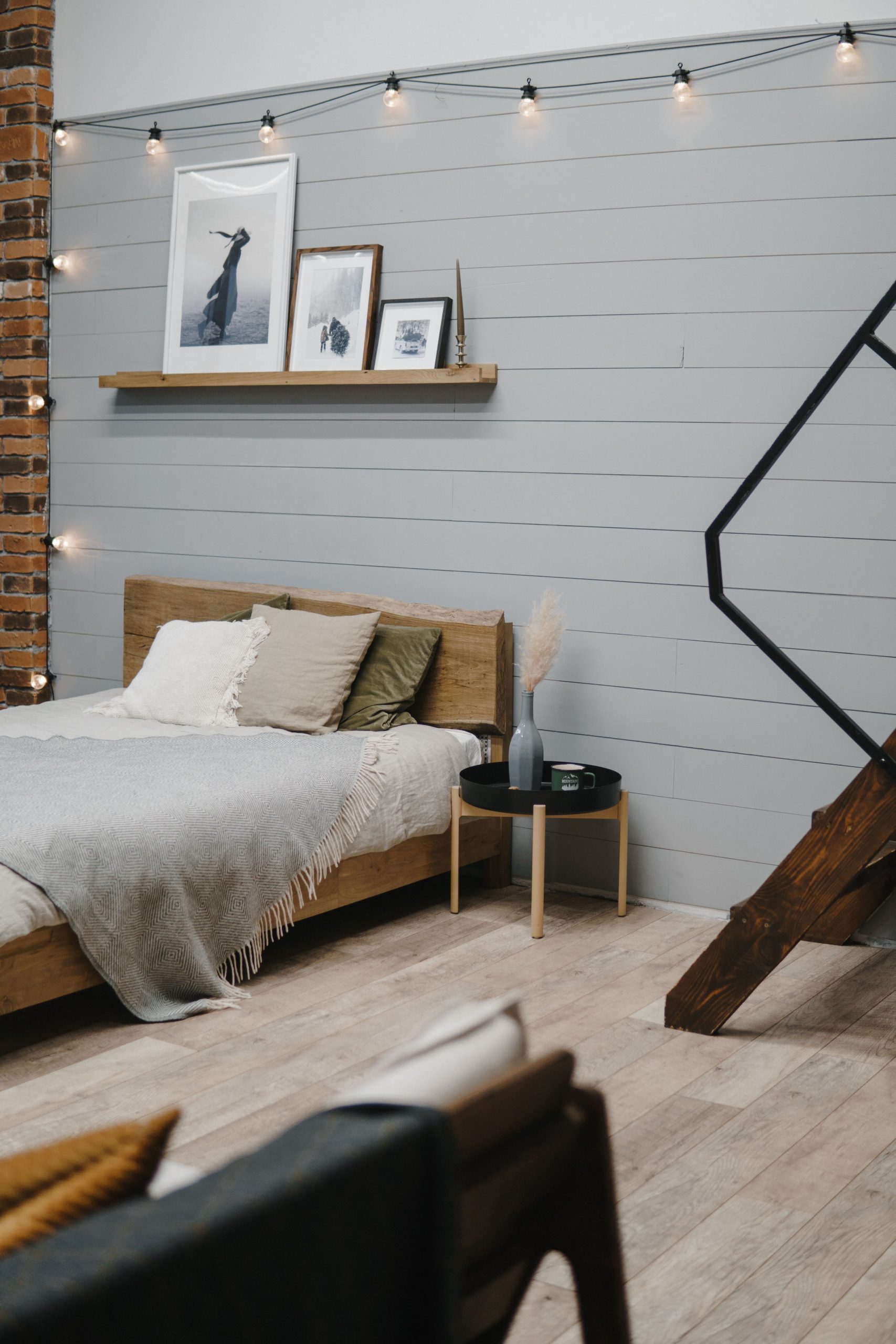 A modern bedroom featuring warm decor, string lights, and contemporary design elements.