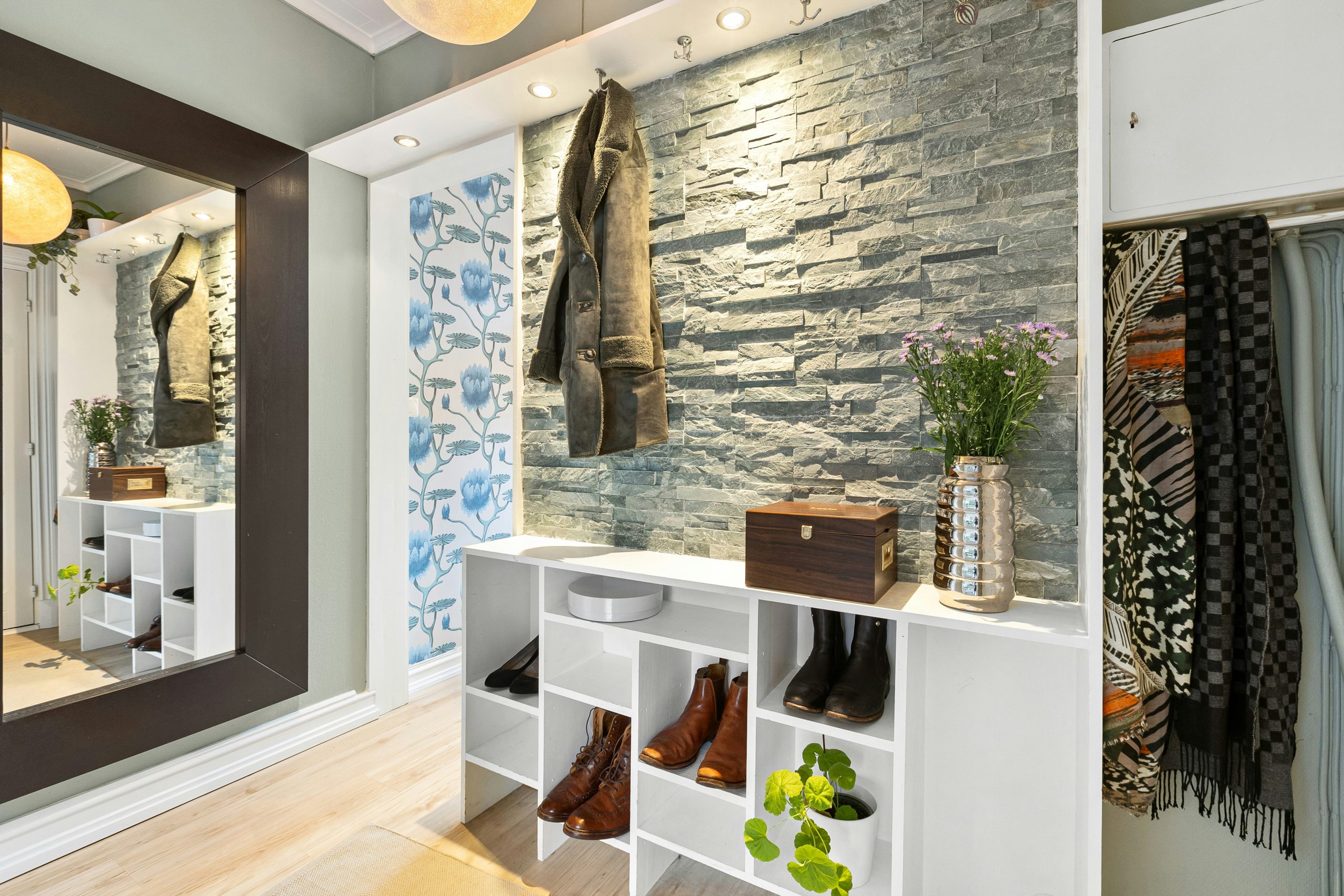 A room with a mirror and a shelf with shoes on it