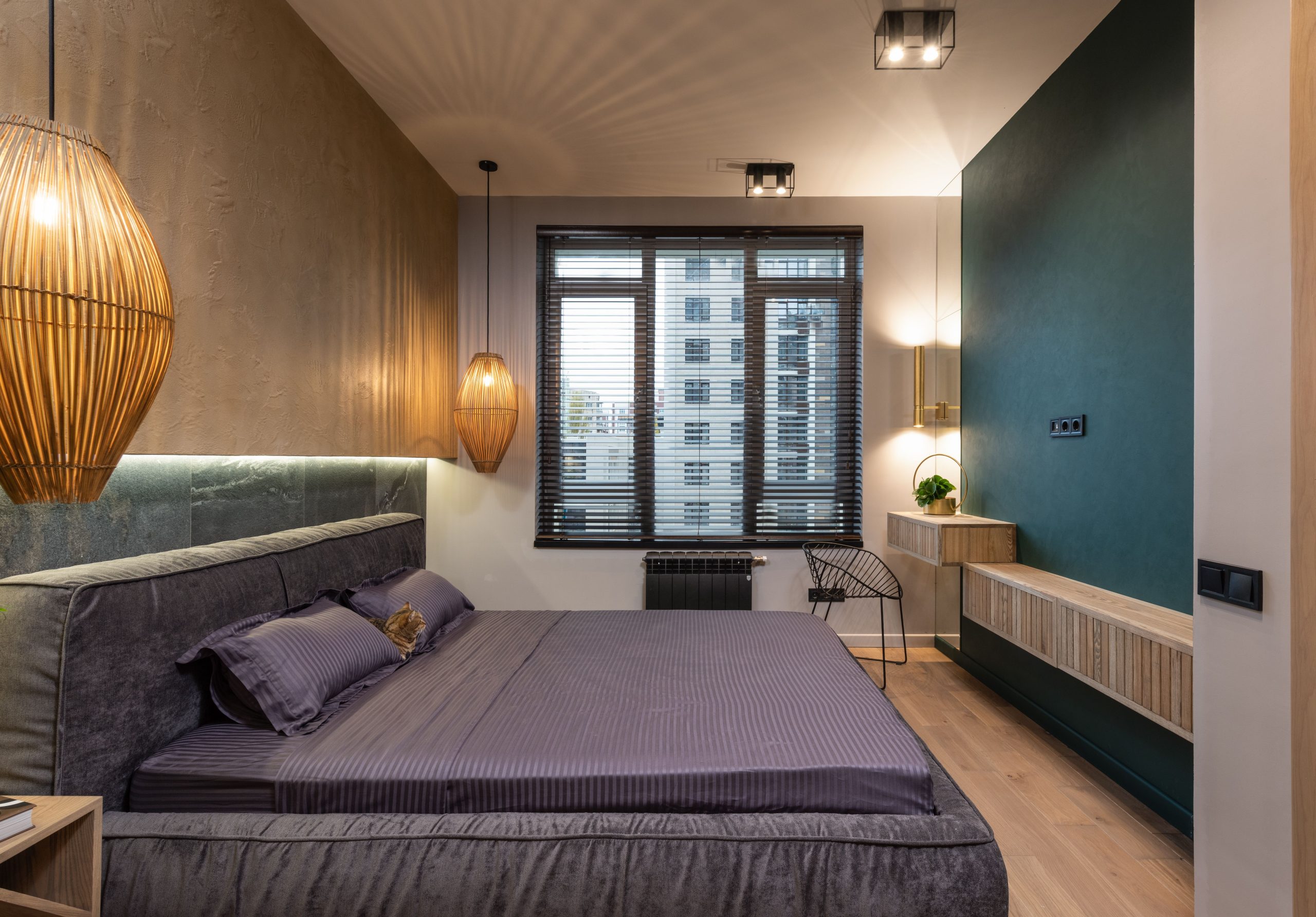 A stylish modern bedroom featuring luxurious decor, ambient lighting, and a city view through the window.