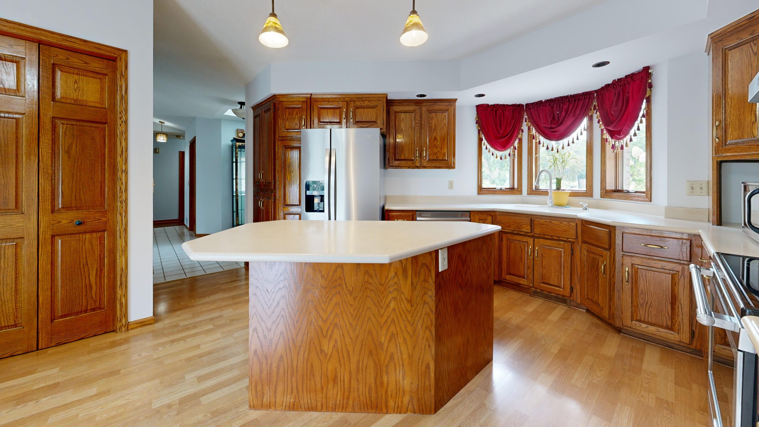Bright kitchen interior with wood cabinets and center island, ideal for a family home.