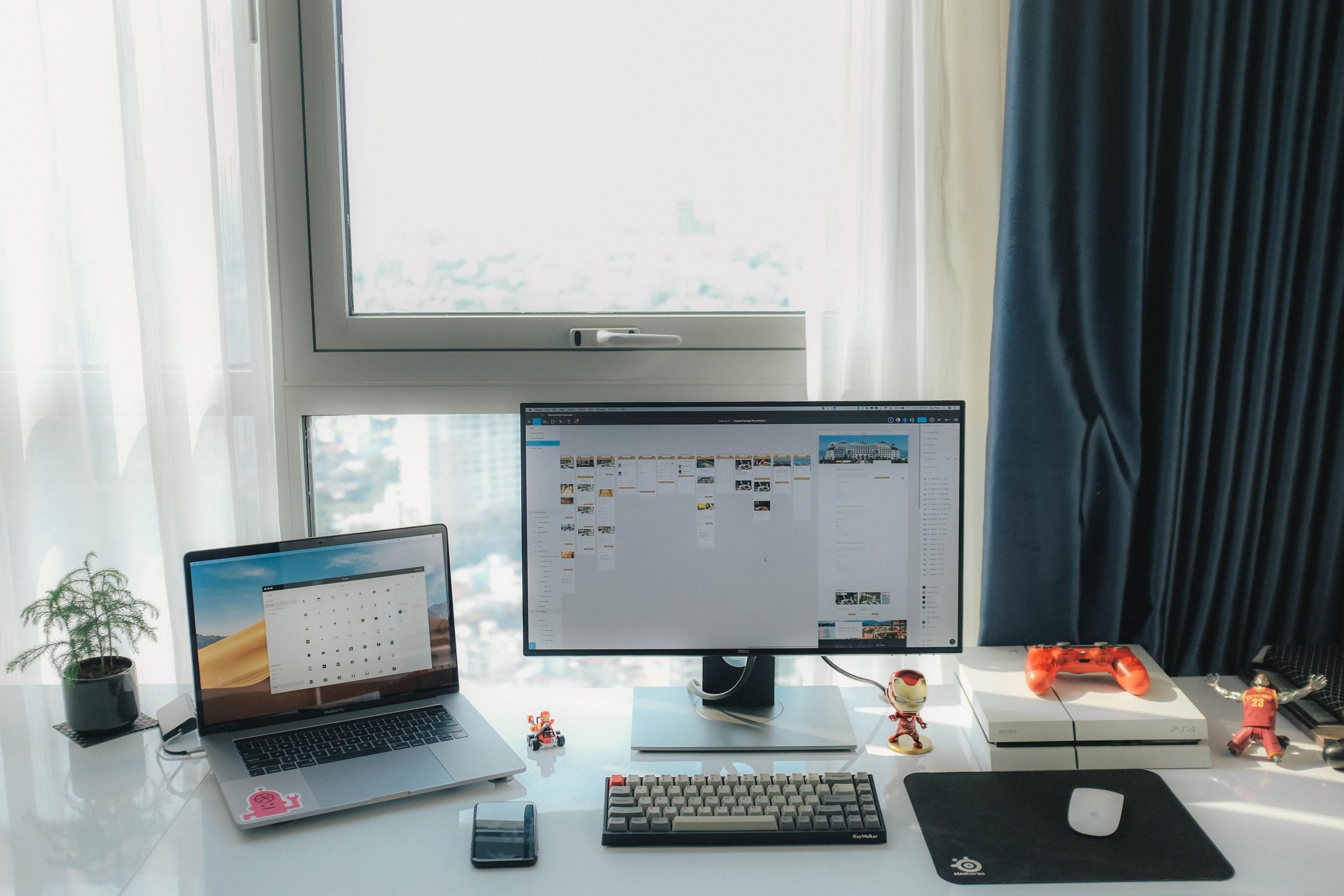 Contemporary home office setup with dual screens and gaming console, ideal for productivity and leisure.