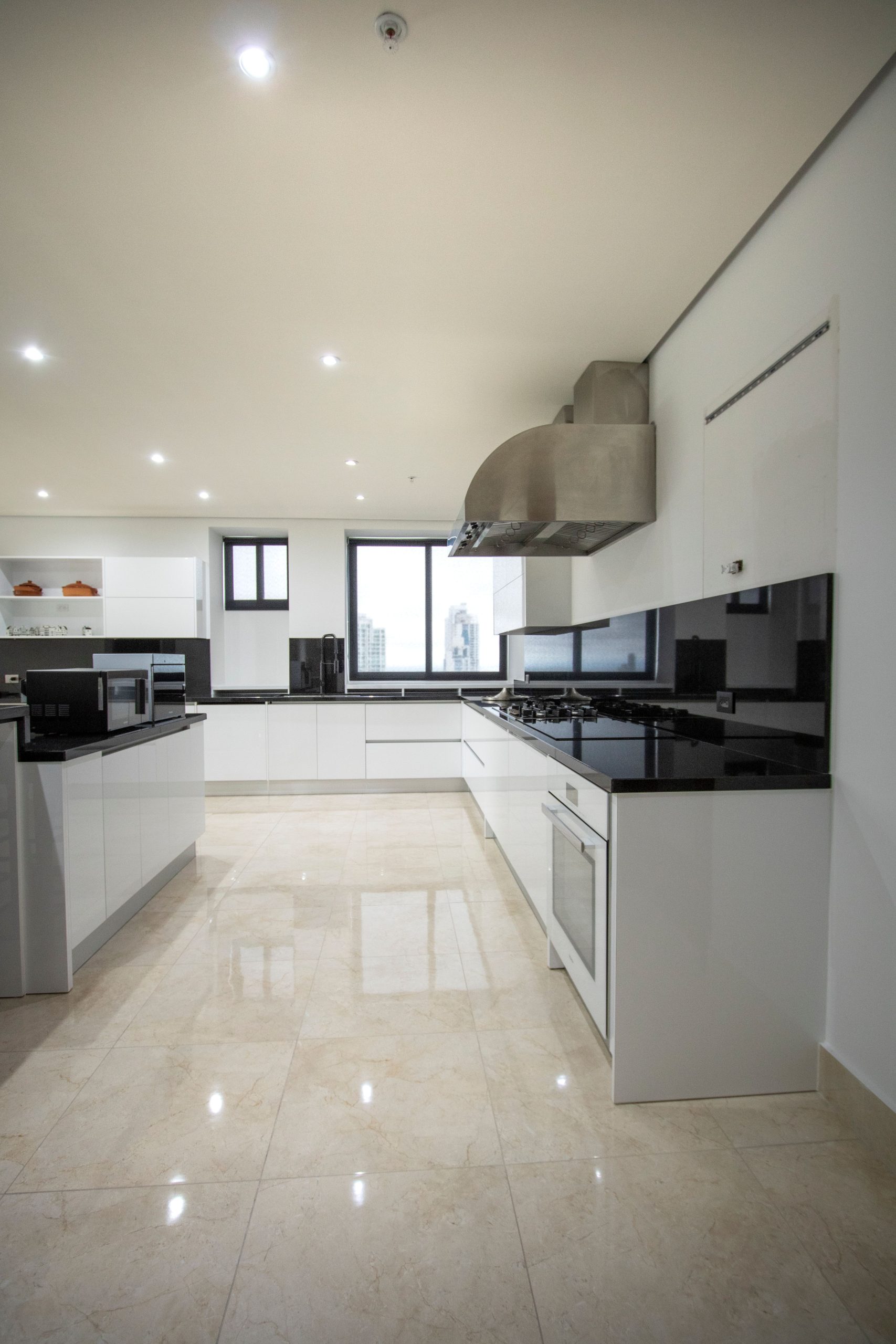 Discover a luxurious modern kitchen with sleek cabinetry and polished surfaces.