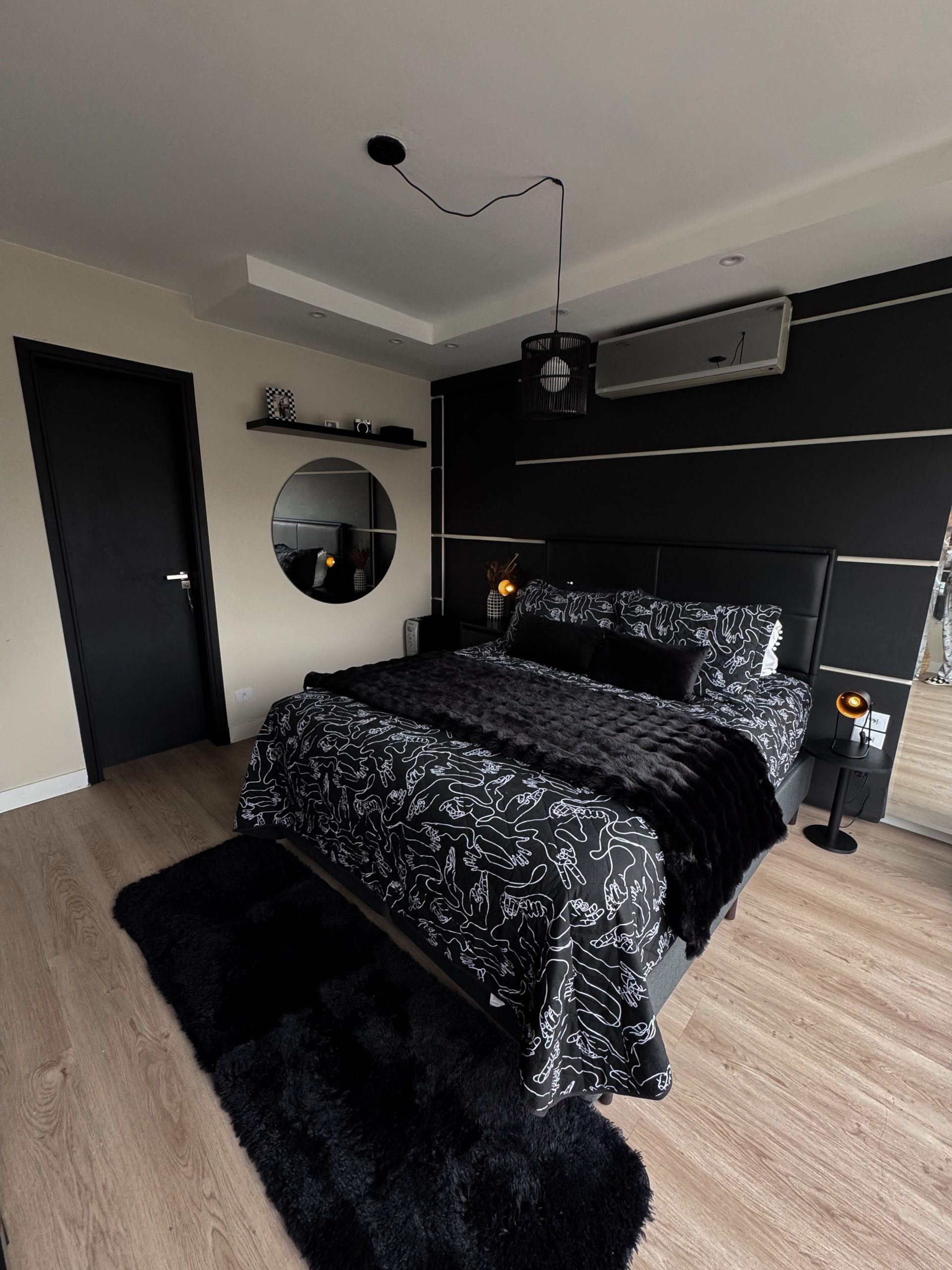 Elegant black-themed bedroom with modern decor and chic design elements.