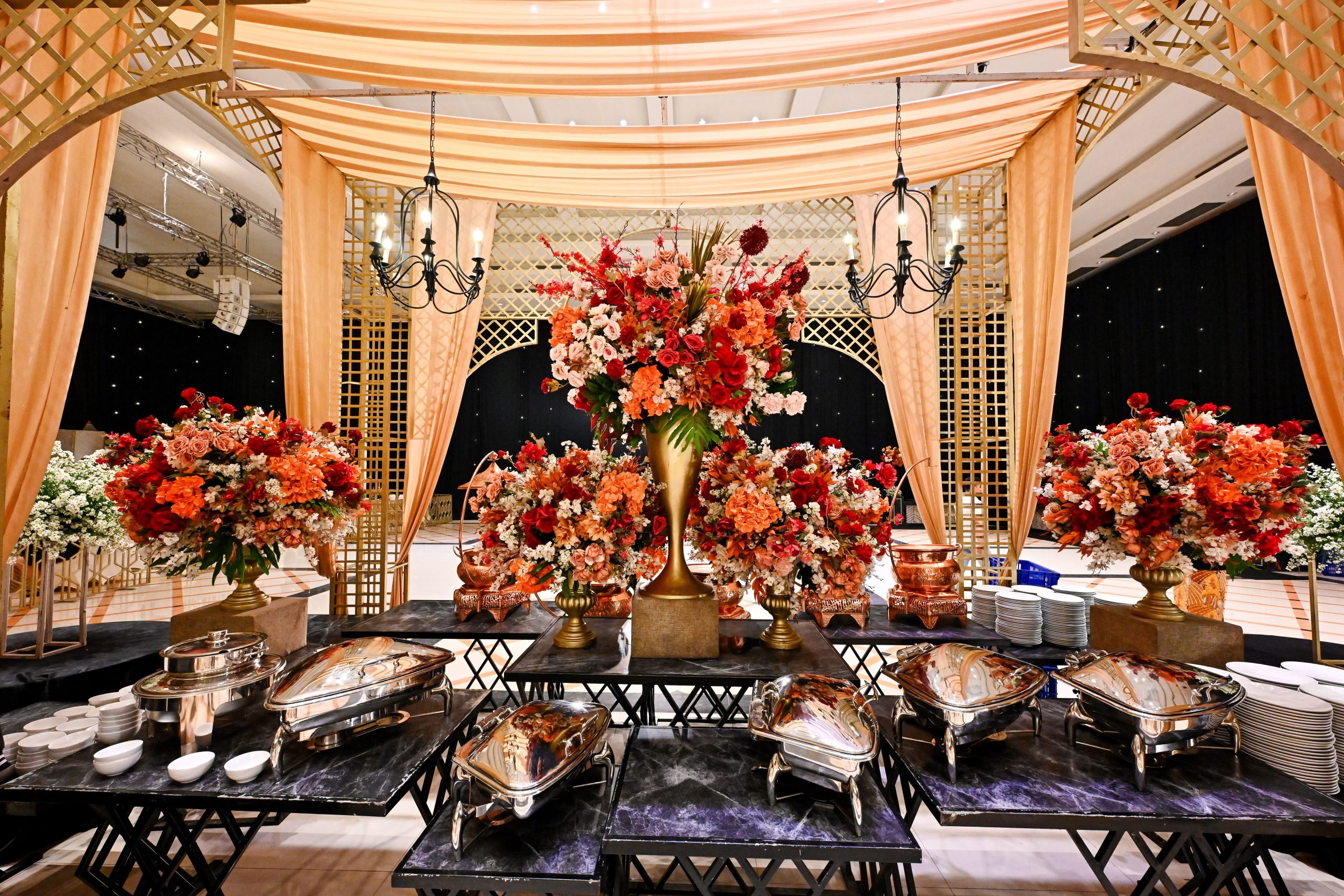 Elegant wedding venue with lavish floral decor and buffet setup in Bandung, Indonesia.