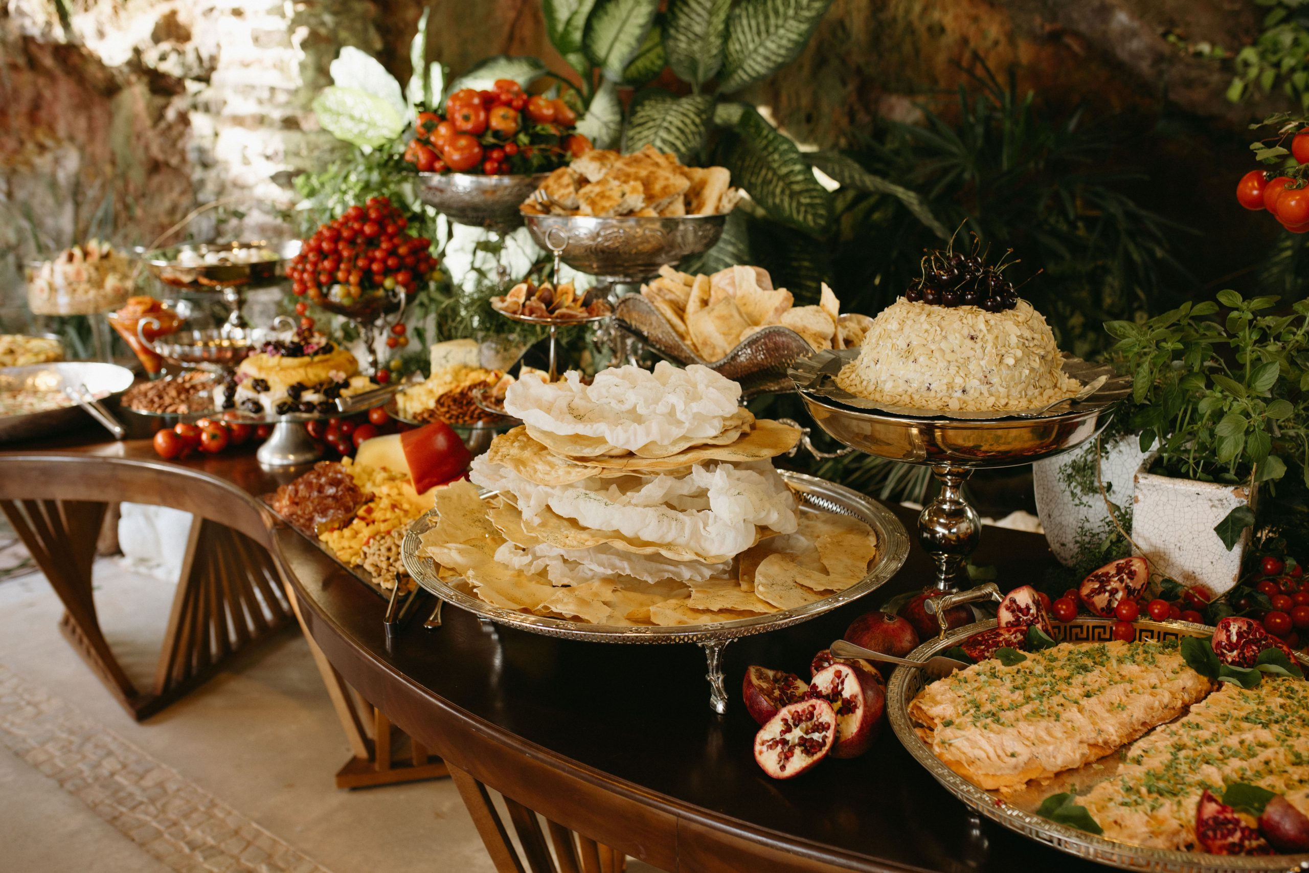 Exquisite buffet table featuring an array of gourmet dishes, fruits, and elegant presentation.