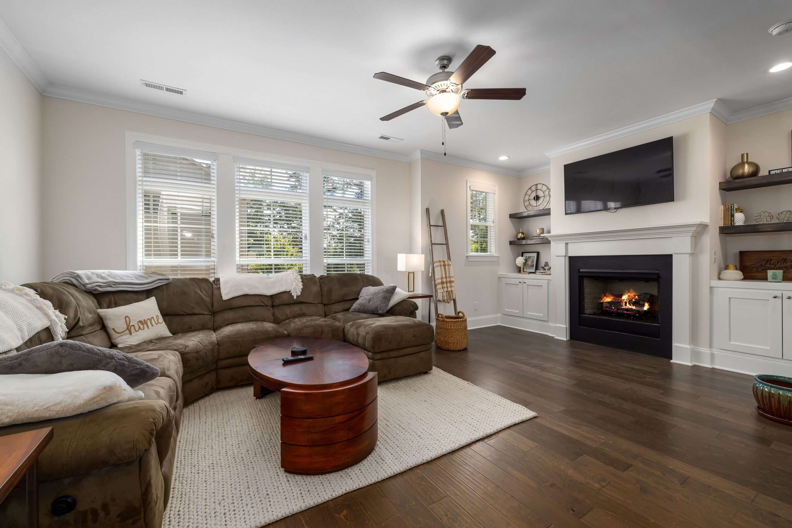 Inviting living room featuring a large sectional sofa and elegant fireplace, perfect for relaxation.