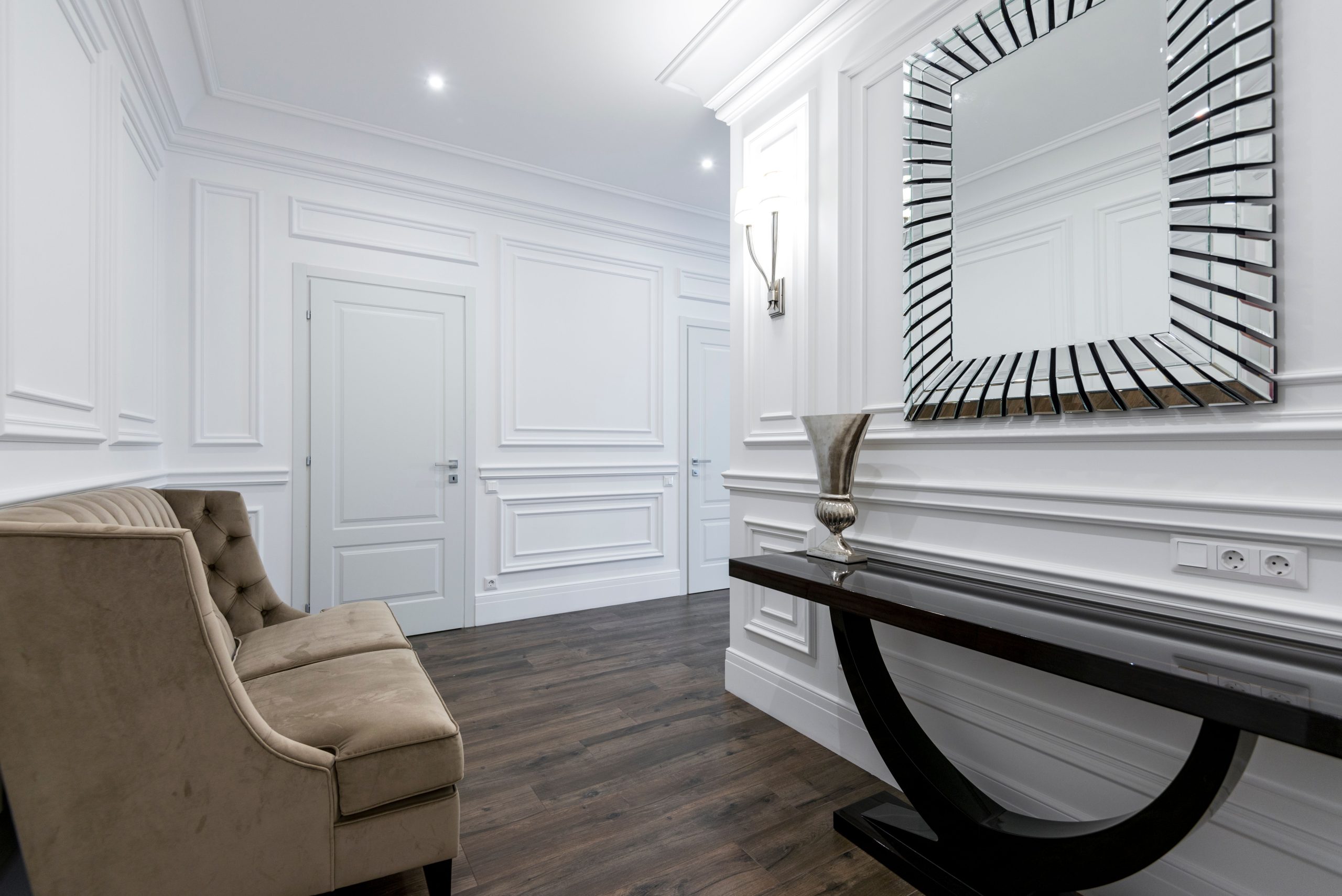 Luxurious hallway featuring a modern mirror, sophisticated sofa, and sleek decor, ideal for real estate and interior design inspiration.