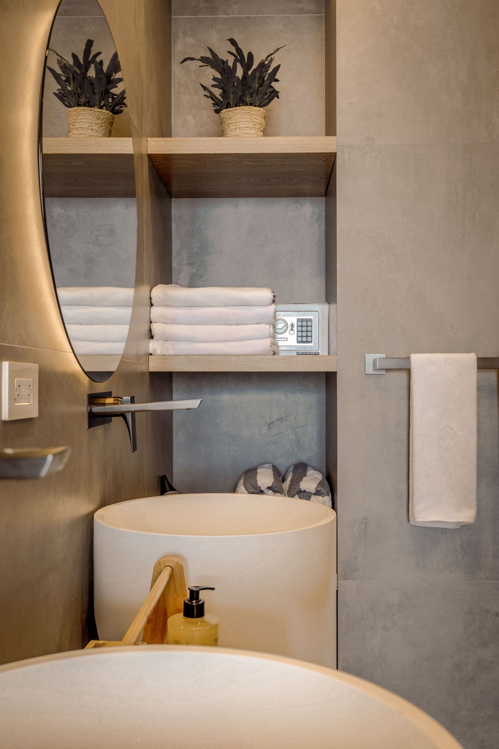 Minimalist bathroom with concrete walls and elegant decor accents.