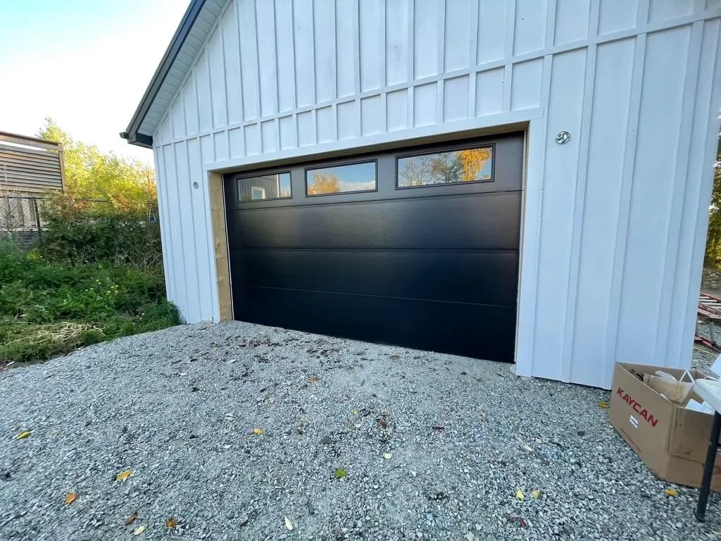 Minimalistic Style Black Garage Door With Glass Inserts