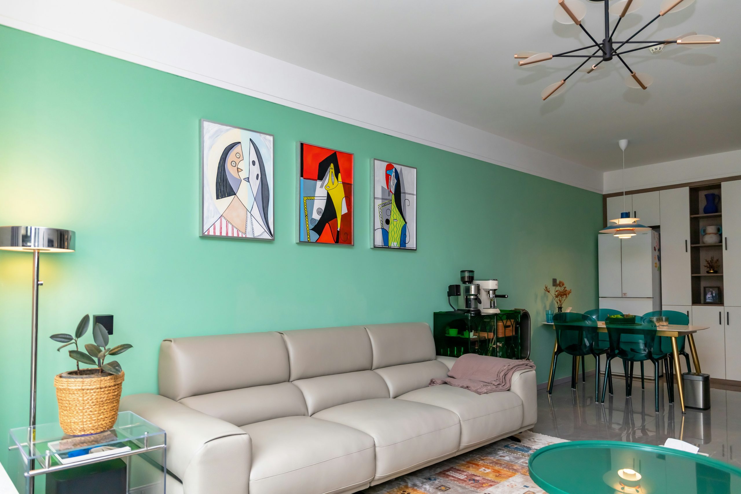 Modern living room with mint green walls and art.