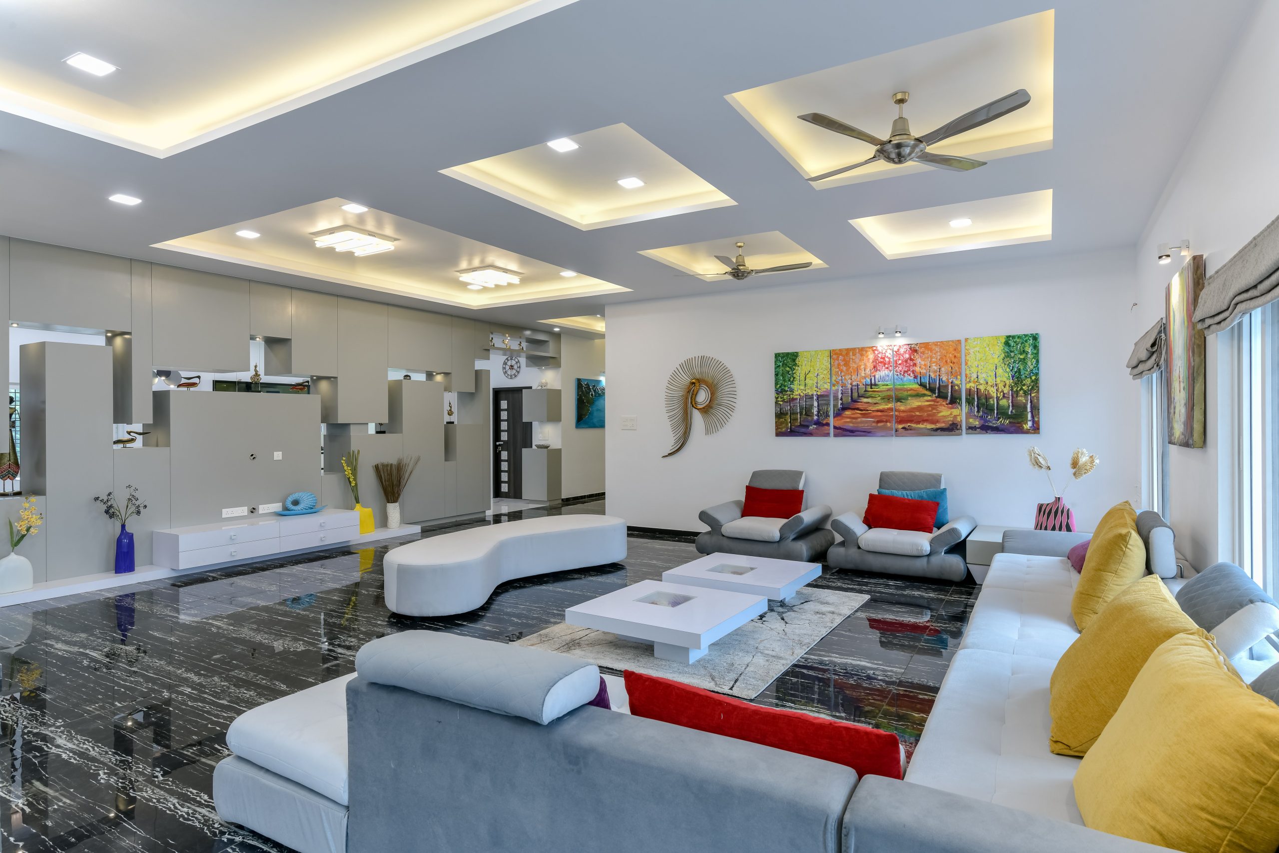 Spacious contemporary living room with elegant furniture and vibrant artwork in a Mumbai home.