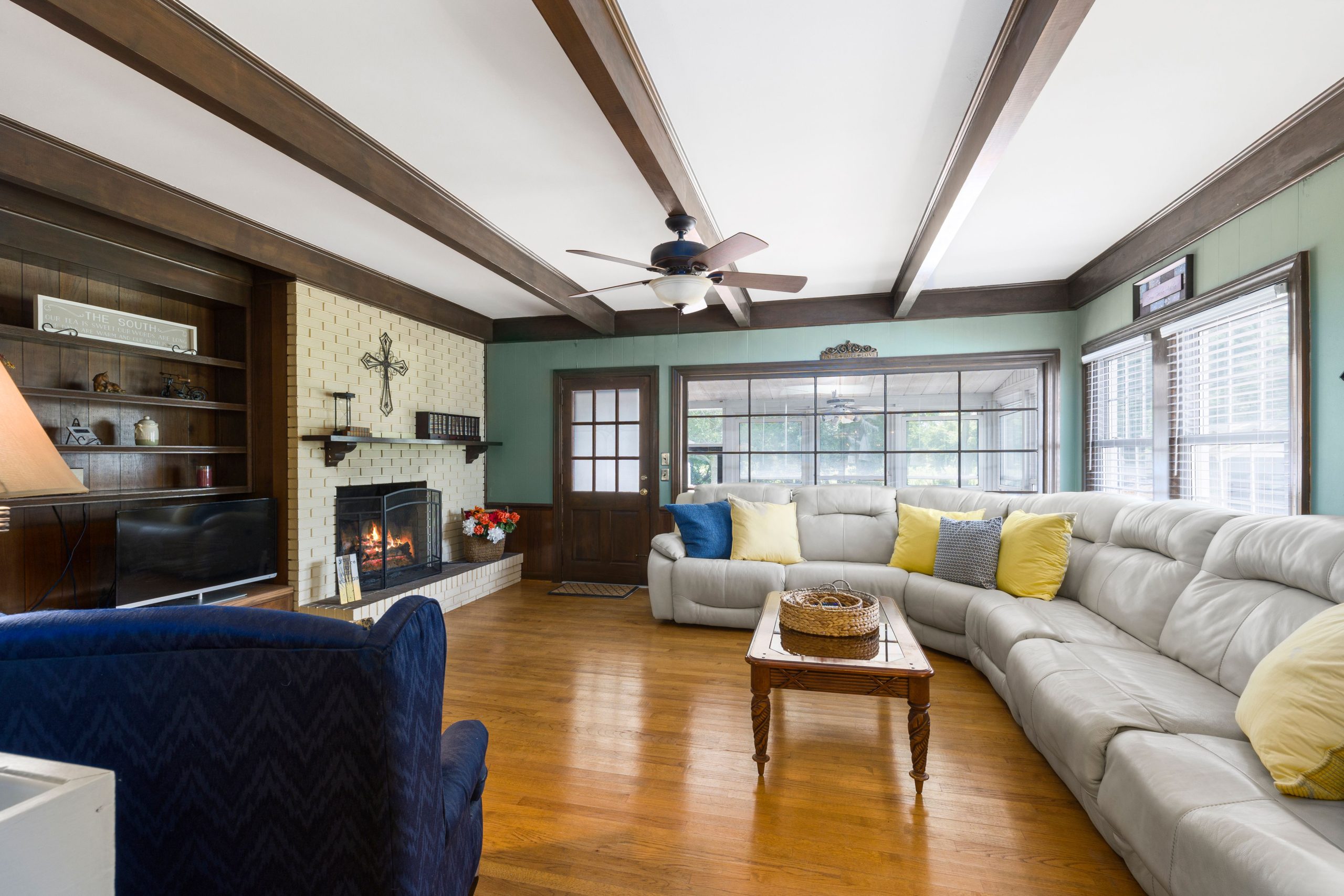 Spacious living room featuring a cozy sectional sofa and fireplace, perfect for relaxation.