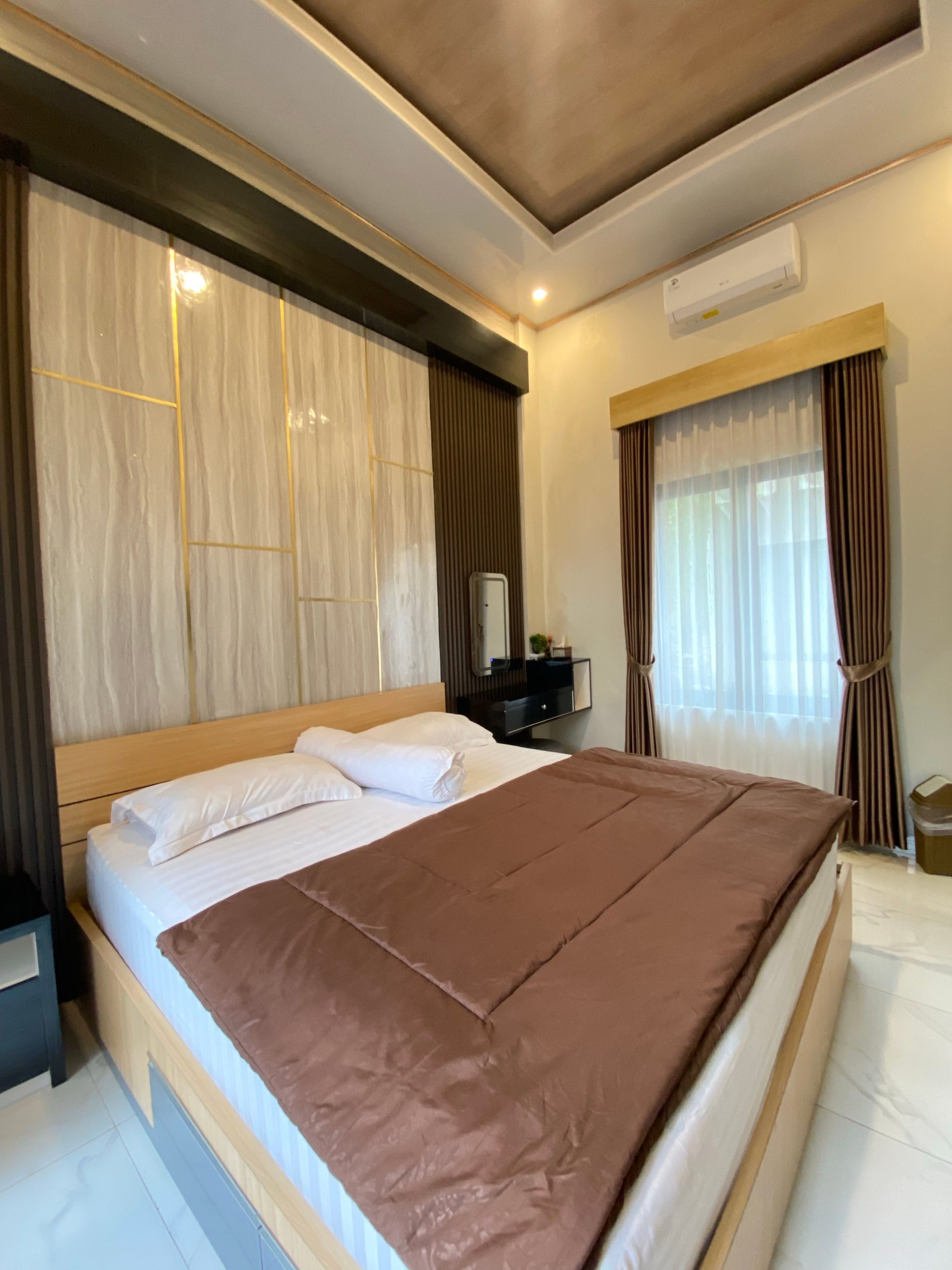 Spacious modern bedroom with comfortable bed and stylish decor.