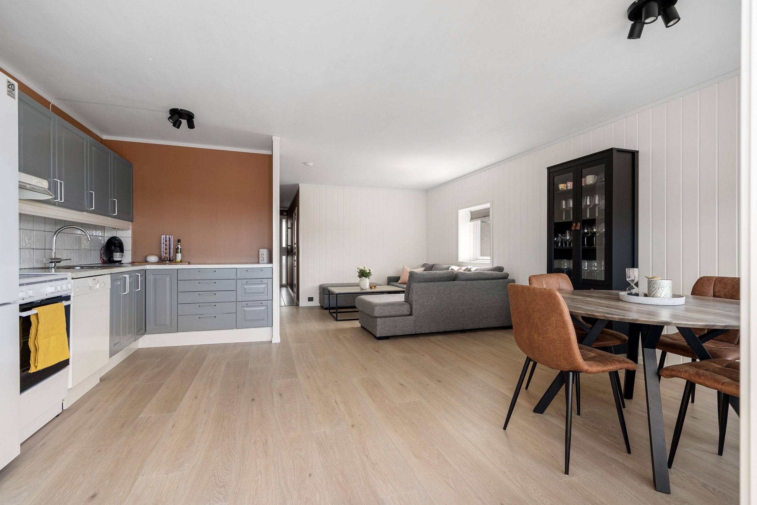 Spacious modern open-plan kitchen and living room with stylish furniture.