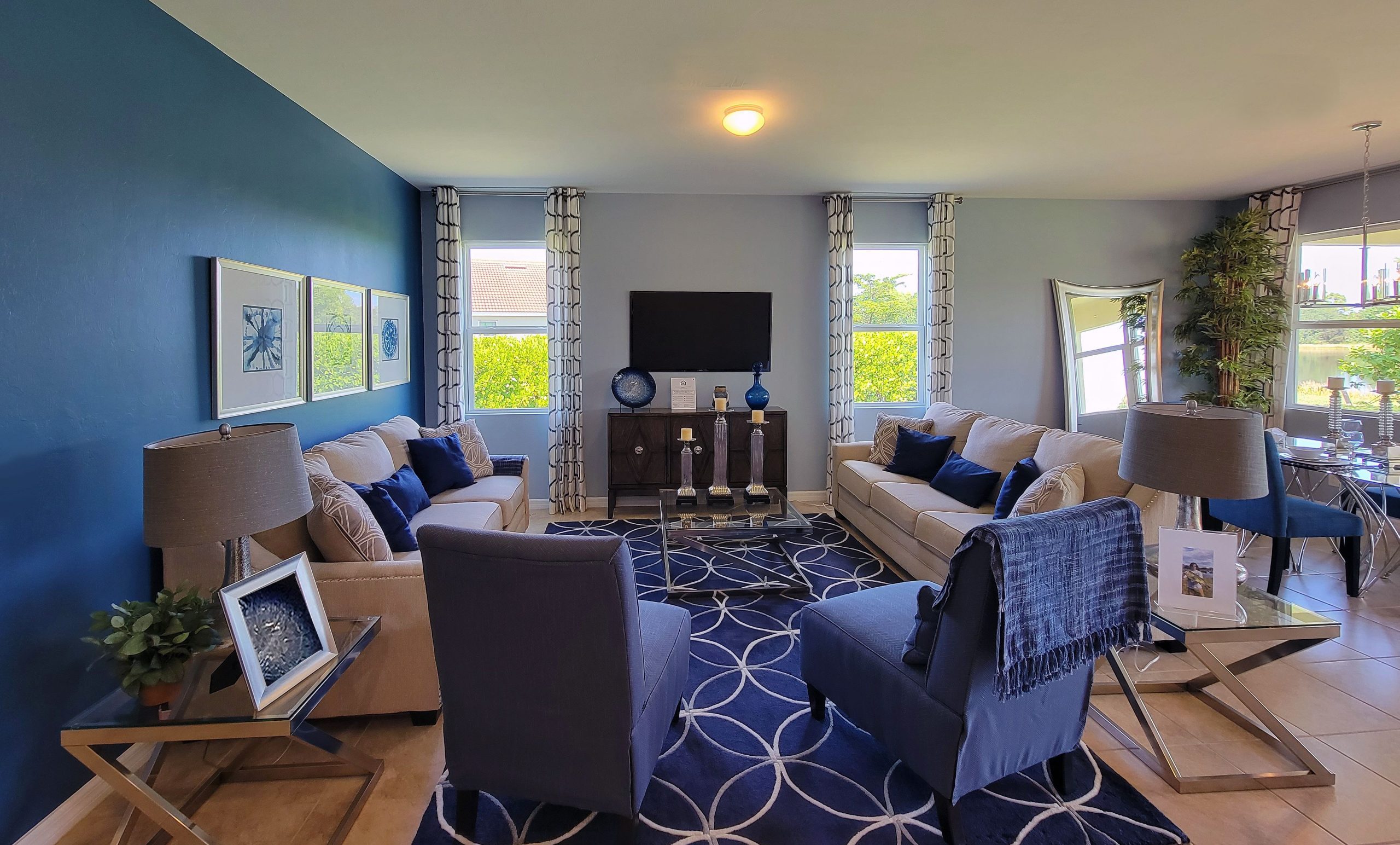 Stylish living room featuring blue and beige tones, contemporary furniture, and elegant decor.