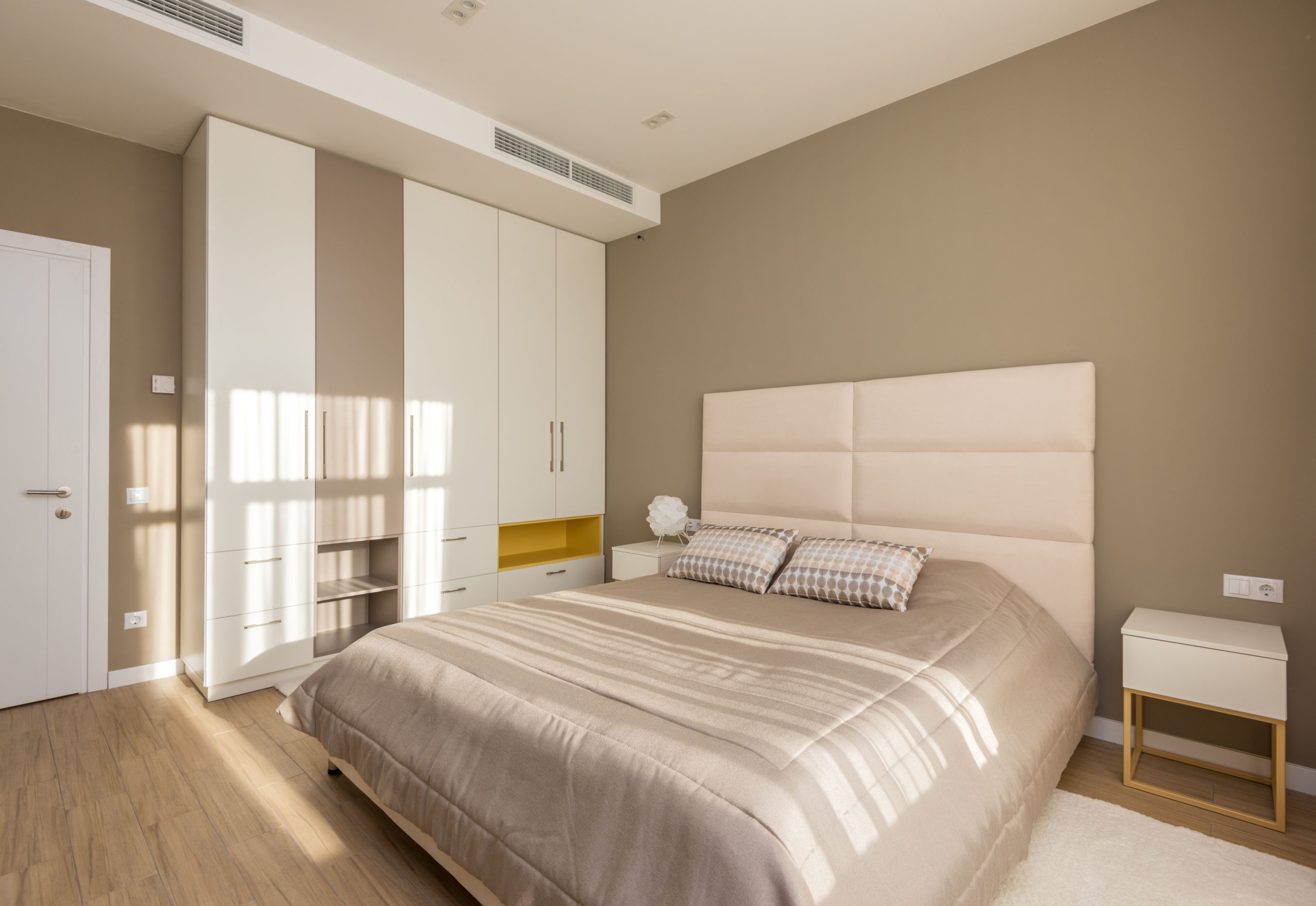 Stylish modern bedroom featuring minimalist design with elegant furniture and soft neutral tones.
