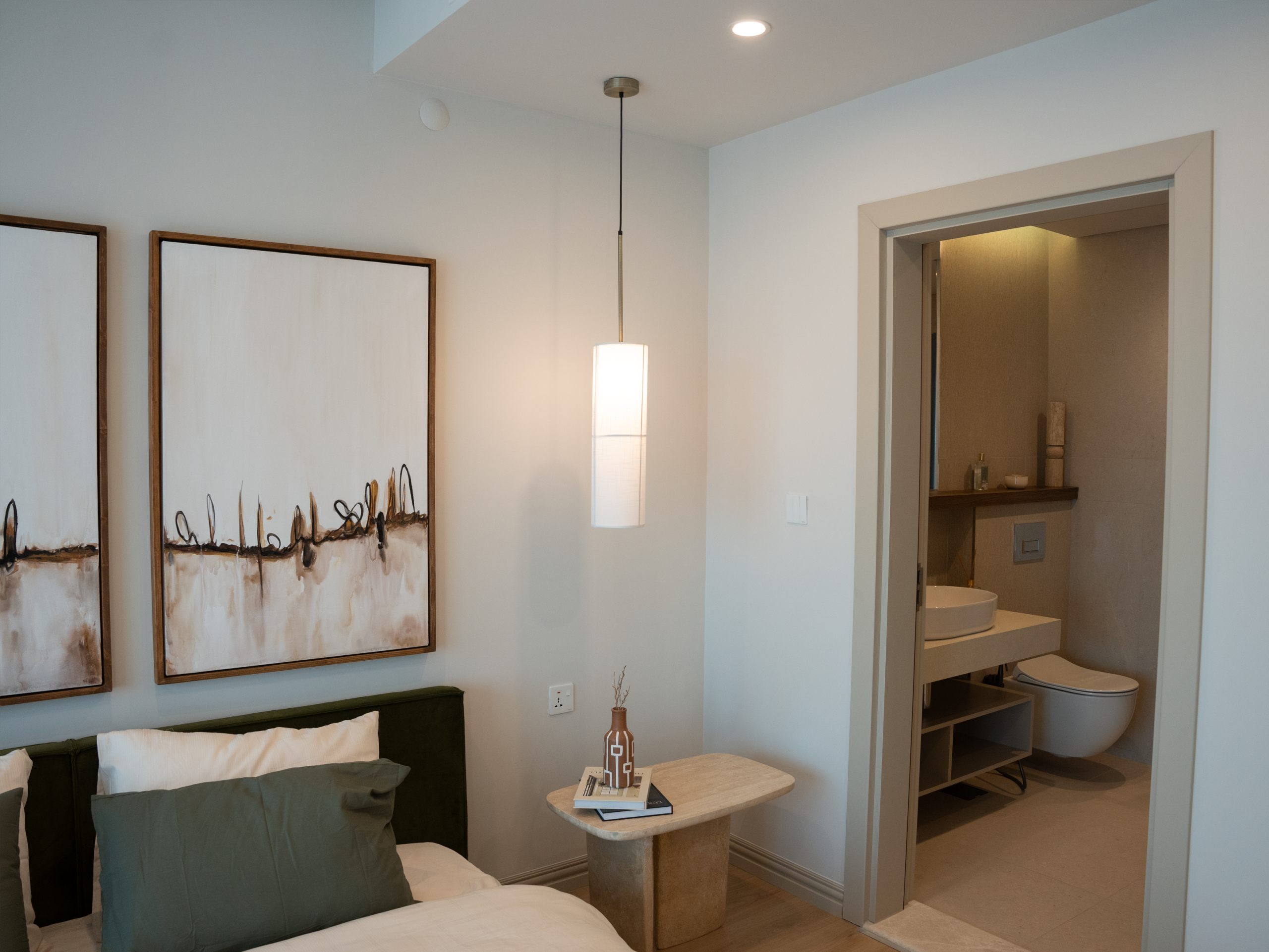 Luxurious minimalist bedroom with modern decor and attached bathroom.
