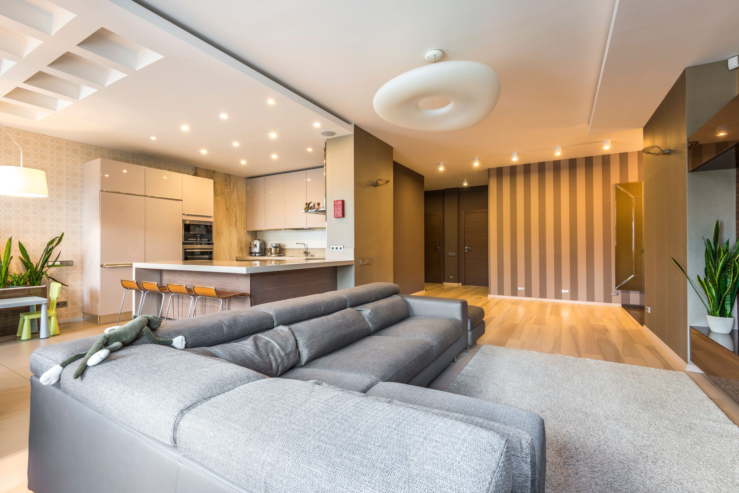 Spacious and elegantly designed open-concept living room with modern kitchen and dining area.